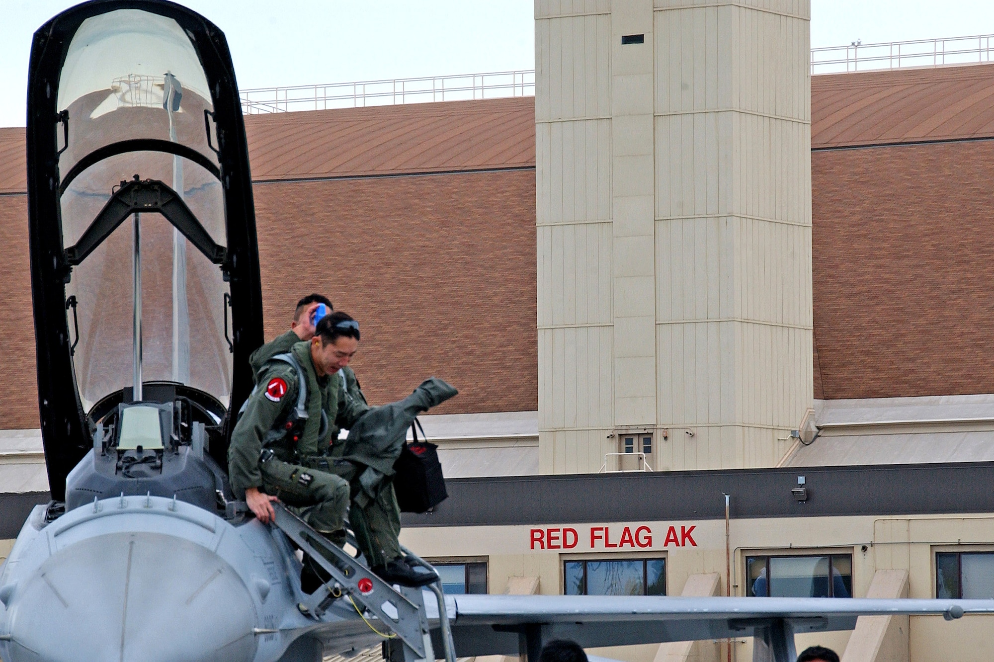 Republic of Singapore Air Force pilots from the 425th Fighter Squadron climb out of their F-16 at Eielson Air Force Base, Alaska, May 30. More than 1,400 military members from the United States, Singapore and Australia are participating in Red Flag-Alaska 07-2, scheduled May 31 to June 15. Red Flag-Alaska, a series of Pacific Air Forces commander-directed field training exercises for U.S. forces, provides joint offensive counter-air, interdiction, close-air support and large-force employment training in a simulated combat environment. (U.S. Air Force photo/Senior Airman Justin Weaver)