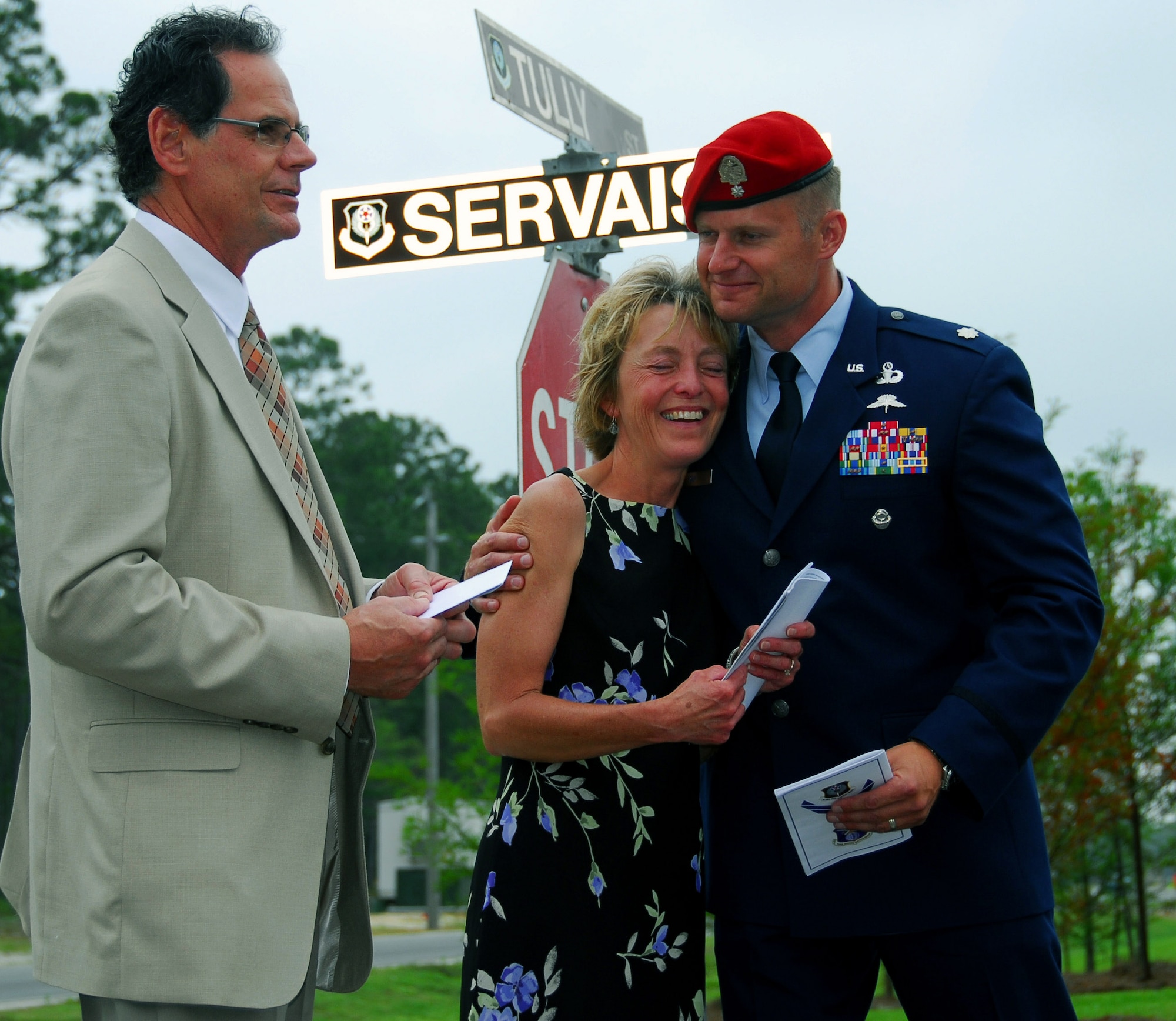 Sue Servais, mother of Senior Airman Adam Servais, a fallen Air Force combat controller, embraces Lt. Col. Eric Ray during a street-naming ceremony May 30 at Hurlburt Field, Fla. Airman Servais' father, Peter, looks on. Airman Servais was killed in a firefight in Afghanistan in August 2006. Colonel Ray is the 23rd Special Tactics Squadron commander. (U.S. Air Force photo/Chief Master Sgt. Gary Emery) 
