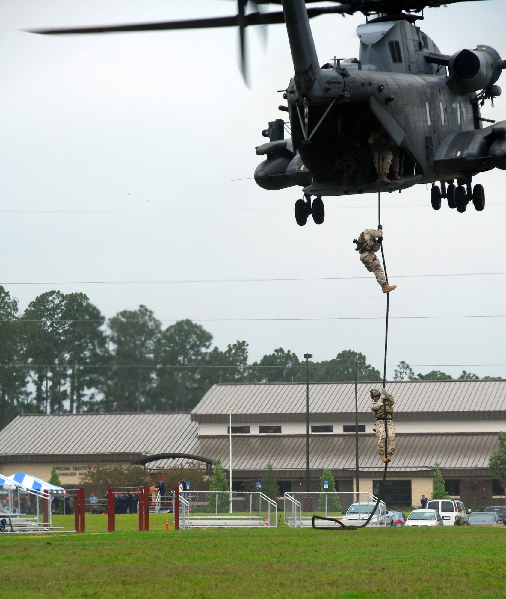 Special tactics Airmen fast rope from an MH-53 Pave Low to deliver the colors at the dedication of the Crate Special Tactics Advanced Skills Training Center May 30 at Hurlburt Field, Fla. The center was dedicated in honor of Staff Sgt. Casey Crate, a combat controller from the 23rd Special Tactics Squadron who perished during an operational mission in Iraq in 2005. (U.S. Air Force photo/Chief Master Sgt. Gary Emery)