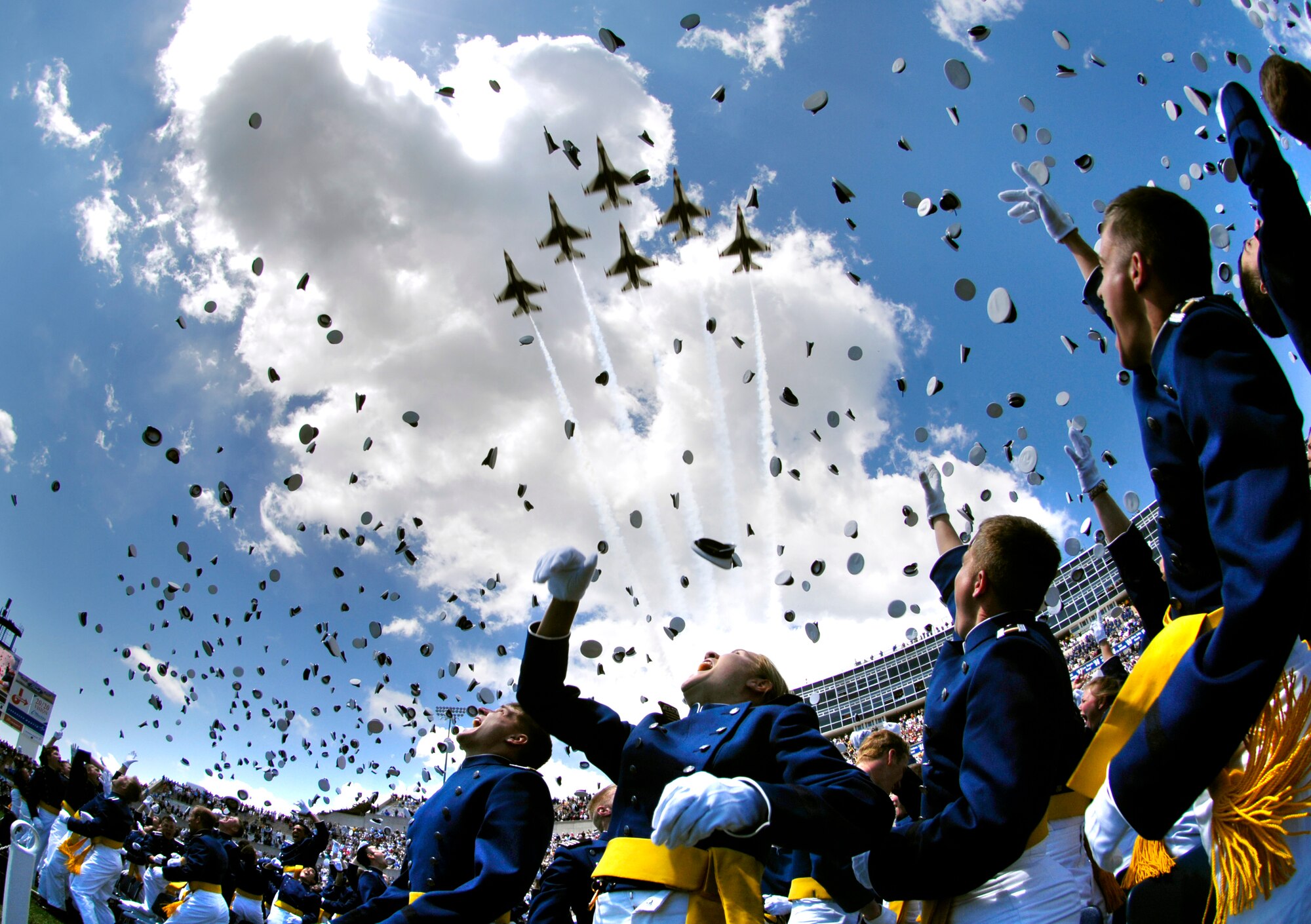 U.S. Air Force Academy graduates throw their hats in the air May 30 as the Air Force Thunderbirds fly overhead signaling the end of the graduation ceremony at the Academy in Colorado Springs, Colo.  (Department of Defense photo/Cherie A. Thurlby)