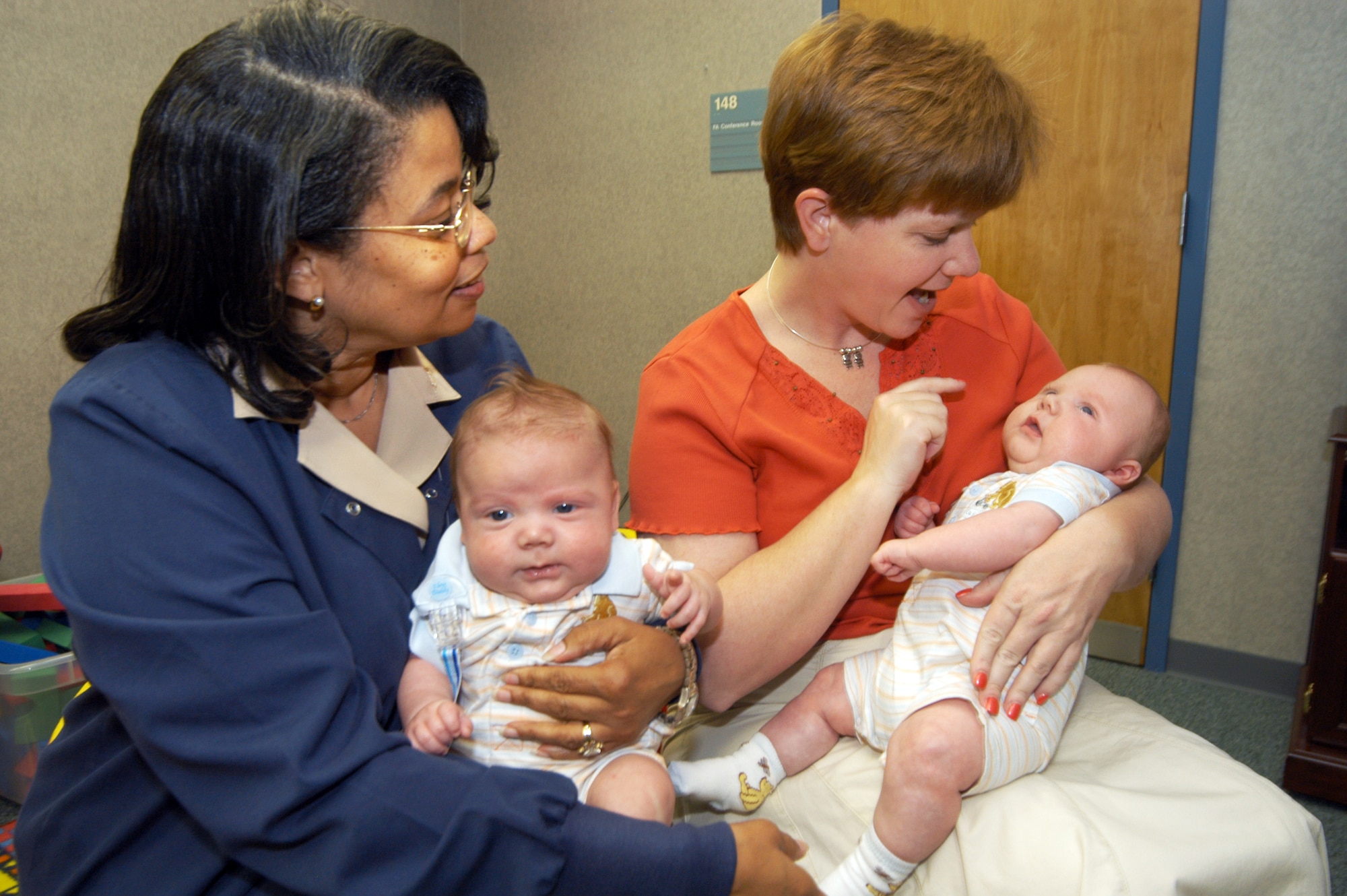 Yvonne Fisk, R.N., assists TSgt. Irish Hester with her twin boys, Brodie and Connor, who were born on Valentine's Day. U. S. Air Force photo by Sue Sapp