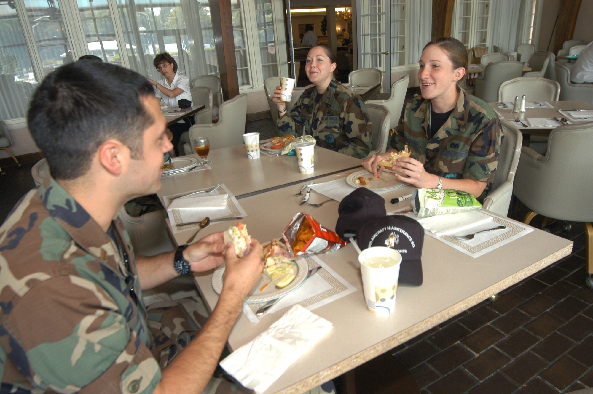 2nd Lt. Eric Hudson, 1st Lt. Debra Ilgenfritz and 2nd Lt. Katie Chiarantona enjoy the dining at the club. U. S. Air Force photo by Sue Sapp  