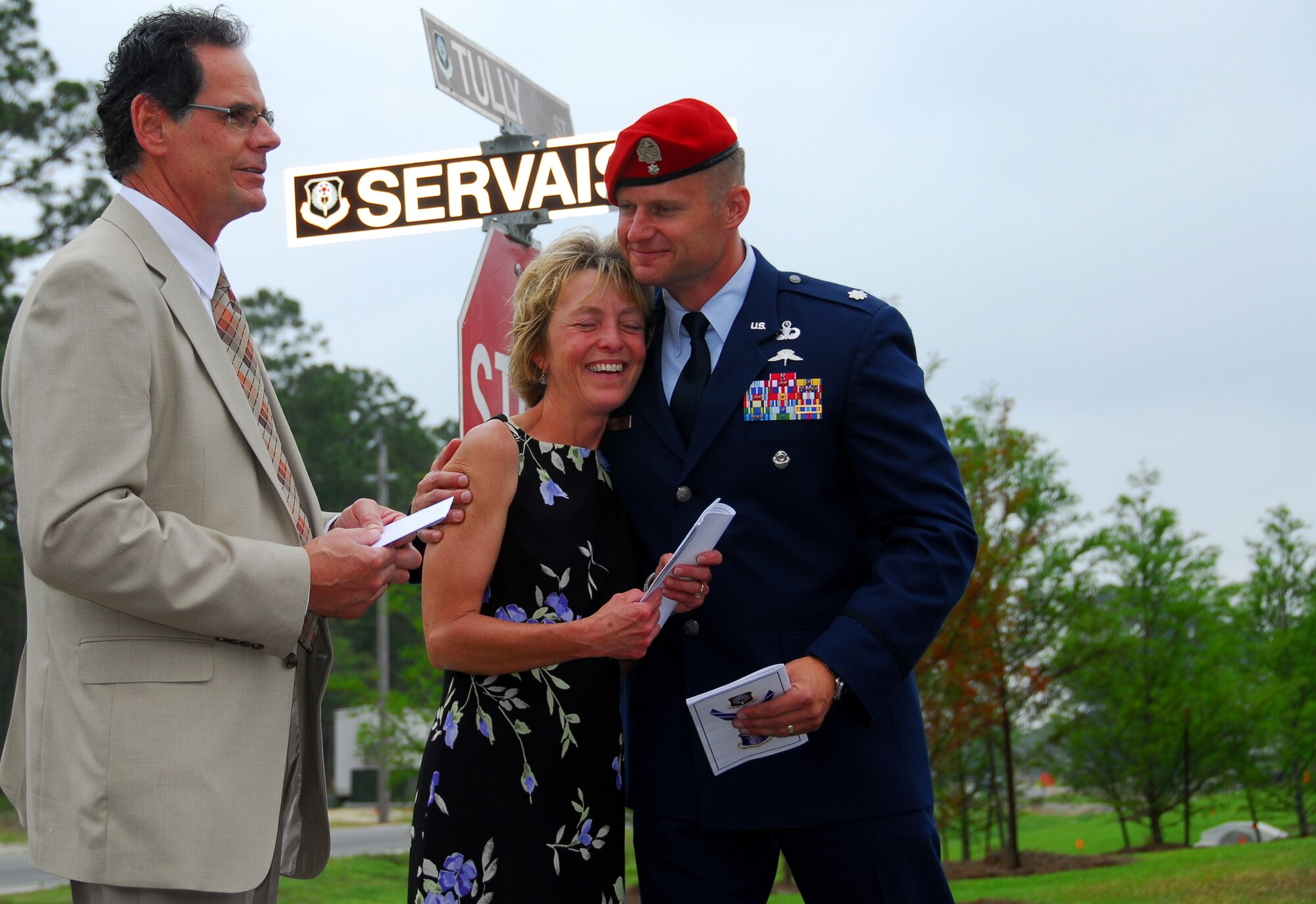 Sue Servais, mother of fallen Air Force combat controller Senior Airman Adam Servais, embraces Lt. Col. Eric Ray, commander of the 23rd Special Tactics Squadron, during a street-naming ceremony at Hurlburt Field, May 30, 2007.  Airman Servais' father, Peter, looks on.  Airman Servais was killed in a firefight in Afghanistan in August, 2006.  (US Air Force photo by Chief Master Sgt. Gary Emery) (Released)  