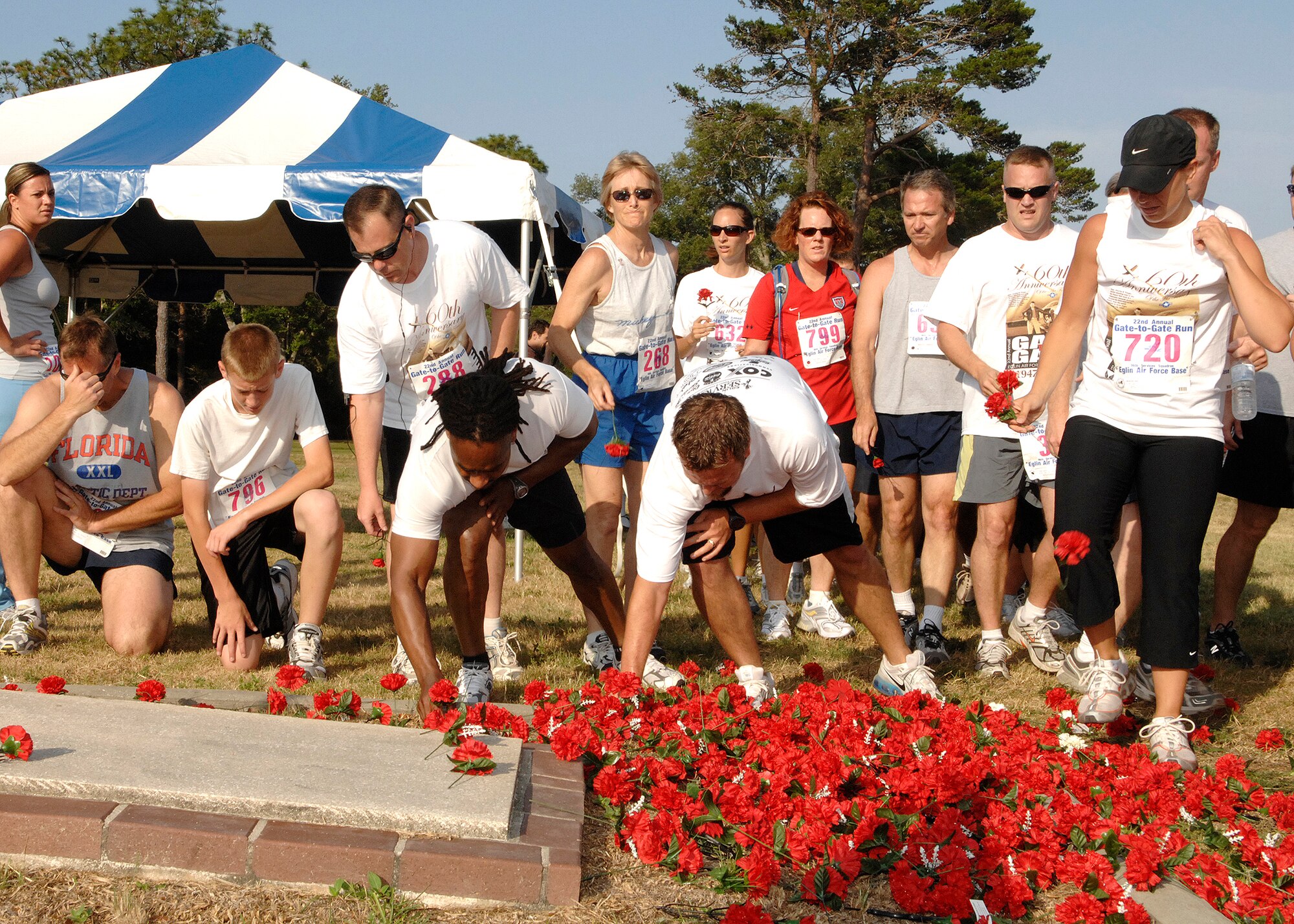 EGLIN AIR FORCE BASE, Fla. -- More than 1,580 runners dropped red carnations at the All-Veterans Memorial during the 22nd Annual Memorial Day Gate-to-Gate run May 28. The run is a 4.4 mile path through Eglin. Traditionally it went from the East Gate to the West gate. Due to safety reasons, the path was changed for this year's event. This year's theme was in honor of the 60th anniversary of the Air Force. (U.S.Air Force photo by Bruce Hoffman)   