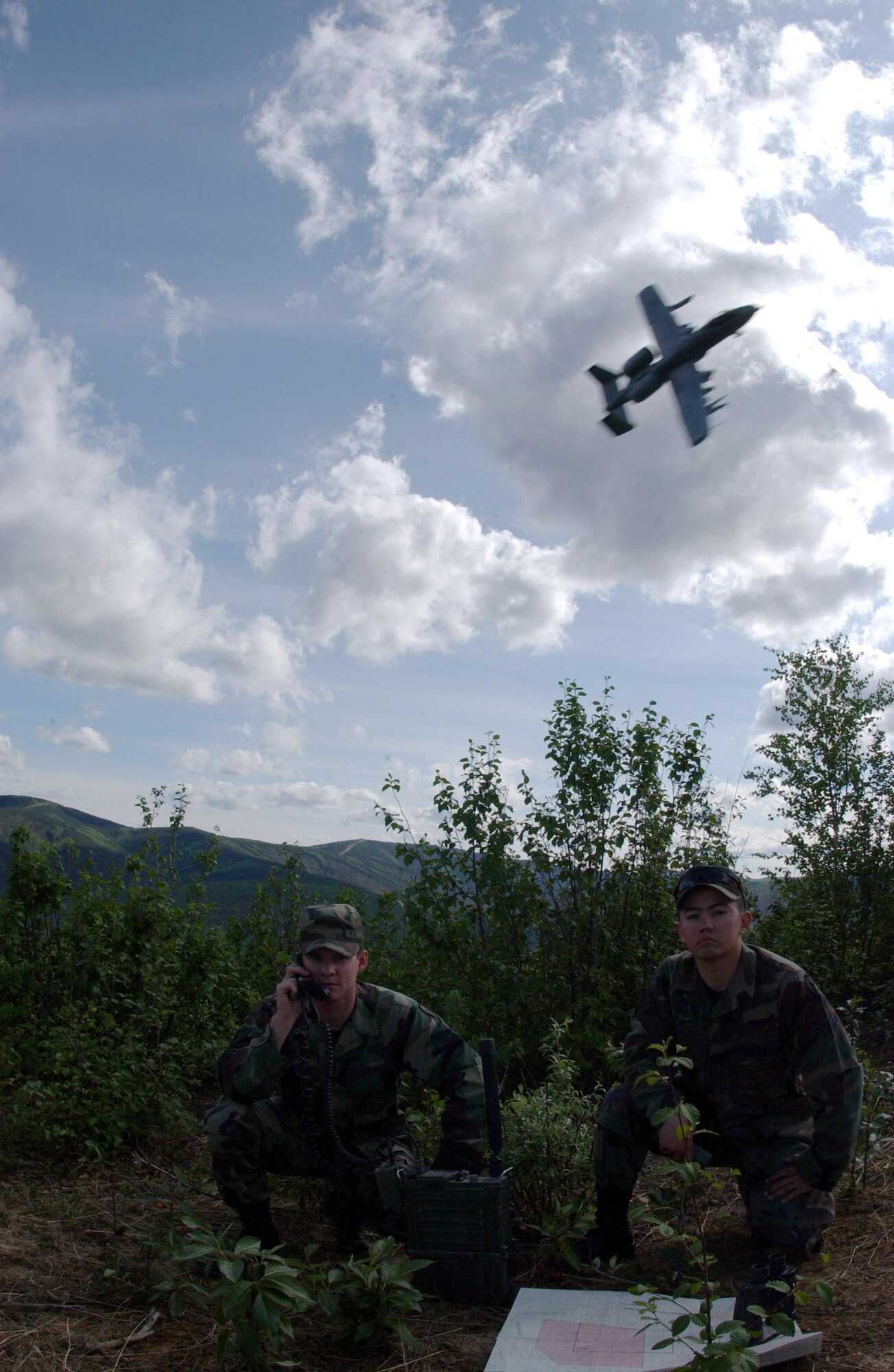 Senior Airman John Tranum and Airman 1st Class Steve Vonack use a PRC-117 multiband tactical radio to communicate with aircraft during an exercise May 29 on the Pacific Alaska Range Complex in Alaska. Airmen Tranum and Vonack are assigned to the 3rd Air Support Operations Squadron tactical air control party from Fort Wainwright, Alaska. 3rd ASOS members coordinate, request and control close-air support, theater airlift, and reconnaissance. (U.S. Air Force photo/Airman 1st Class Jonathan Snyder)
