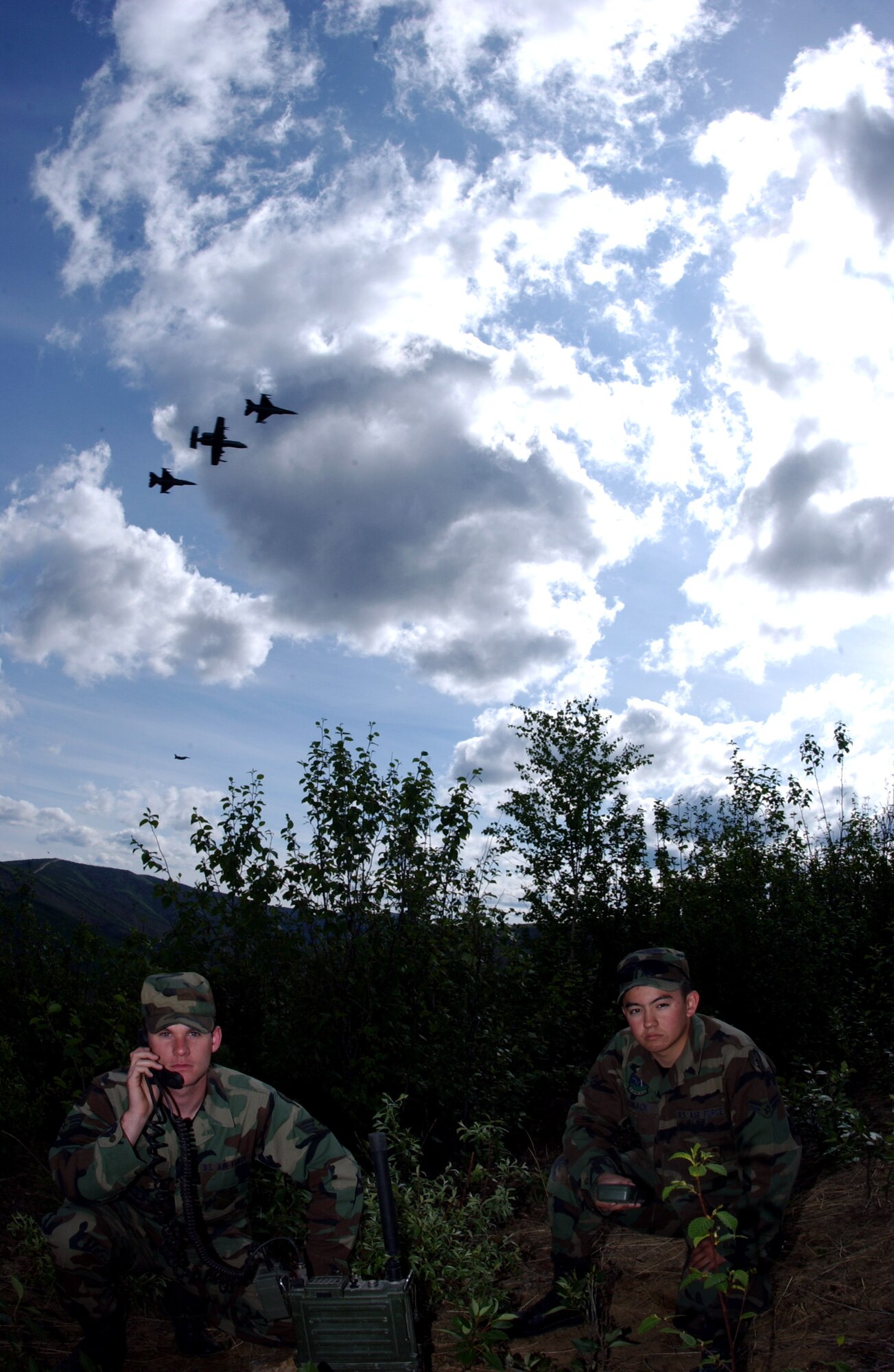 Senior Airman John Tranum and Airman 1st Class Steve Vonack use a PRC-117 multiband tactical radio to communicate with aircraft during an exercise May 29 on the Pacific Alaska Range Complex in Alaska. Airmen Tranum and Vonack are assigned to the 3rd Air Support Operations Squadron tactical air control party from Fort Wainwright, Alaska. 3rd ASOS members coordinate, request and control close-air support, theater airlift, and reconnaissance. (U.S. Air Force photo/Airman 1st Class Jonathan Snyder)
