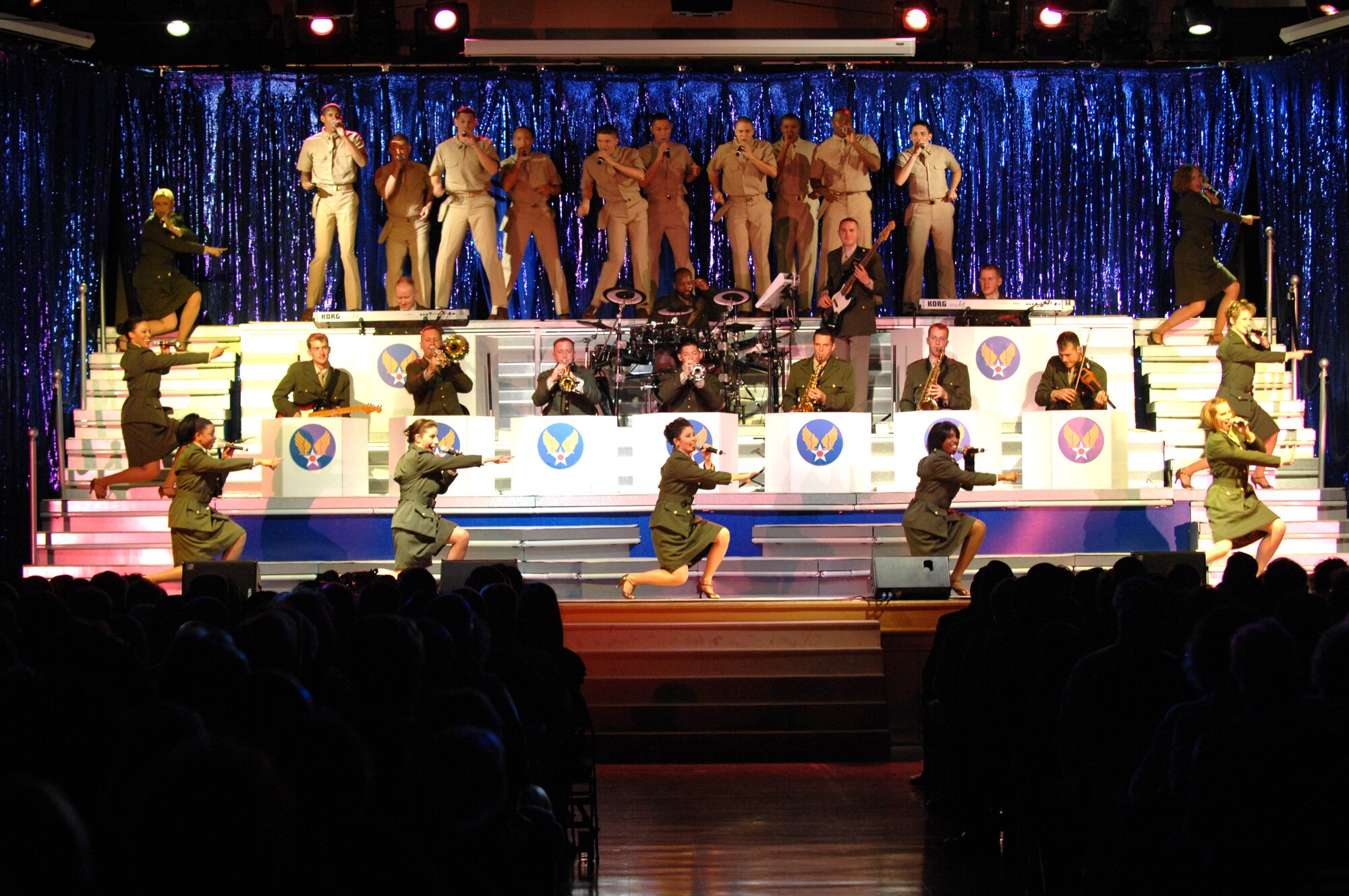 Tops in Blue Airmen sing and perform before a crowd May 24 at the Tays Center near Holloman Air Force Base in Alamogordo, N.M. Tops In Blue Airmen perform an average of 120 performances at 100 locations worldwide each year members around the world. Tops in Blue showcases music, dance and comedy, all performed by active-duty Airmen who perform 90 minutes of non-stop live entertainment. (U.S. Air Force photo/Senior Airman Anthony Nelson) 
