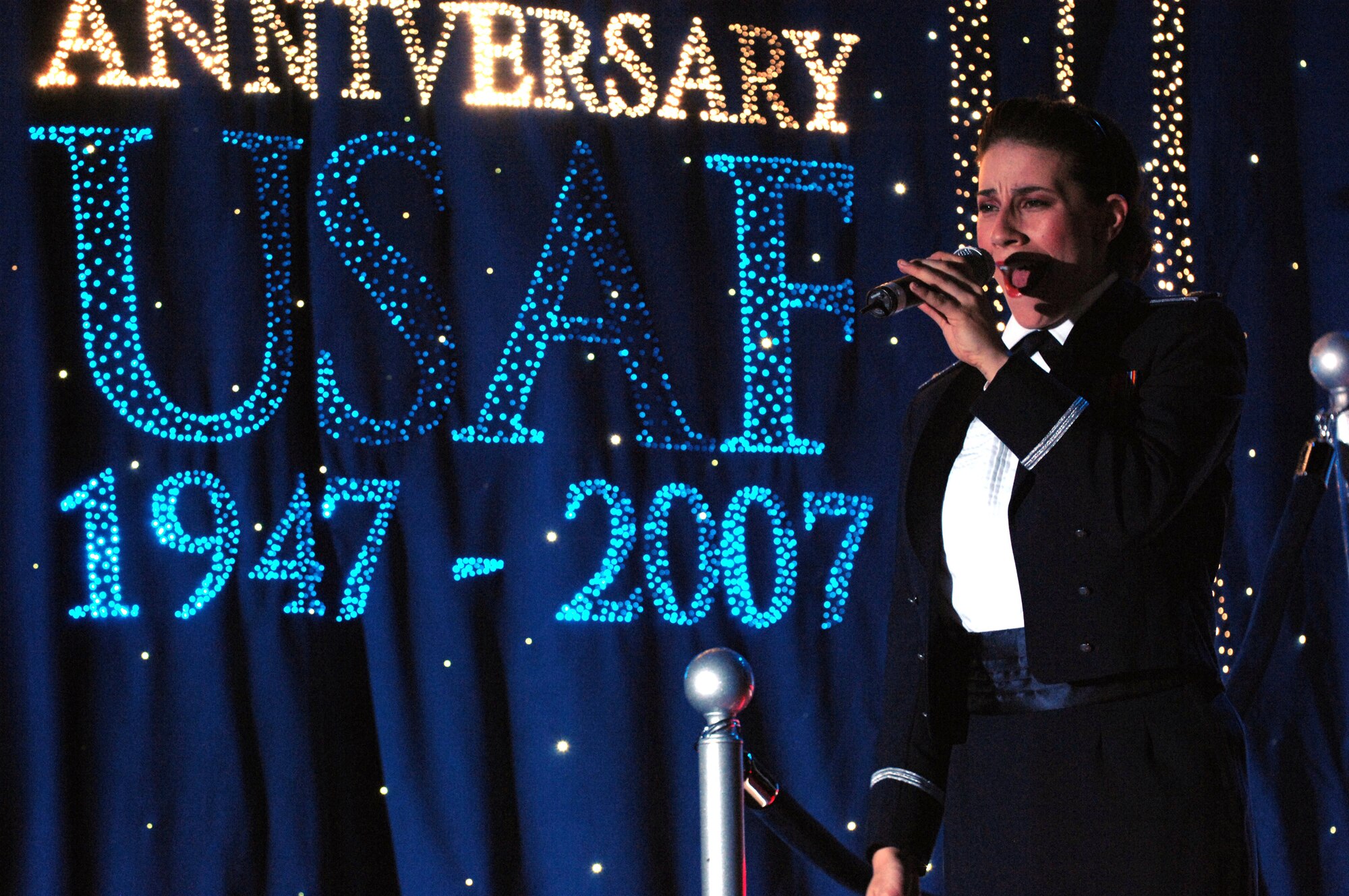 A Tops in Blue Airman sings to the crowd May 24 at the Tays Center near Holloman Air Force Base in Alamogordo, N.M. The 40-member group's goal is to enhance mission productivity for Air Force members around the world. Tops in Blue showcases music, dance and comedy, all performed by active-duty Airmen who perform 90 minutes of non-stop live entertainment. (U.S. Air Force photo/Senior Airman Anthony Nelson)
