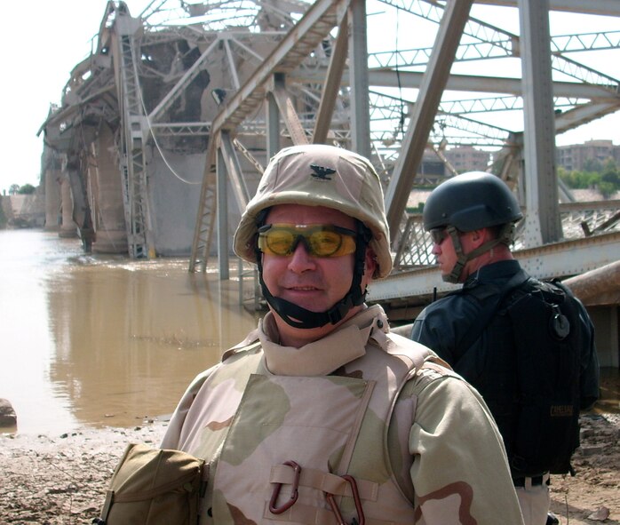 BAGHDAD, Iraq -- Col. Paul T. Babin Jr., a former Commander 439th Civil Engineering Squadron, inspects the remains of a destroyed bridge that once spanned the Tigris River. (U.S. Air Force photo)