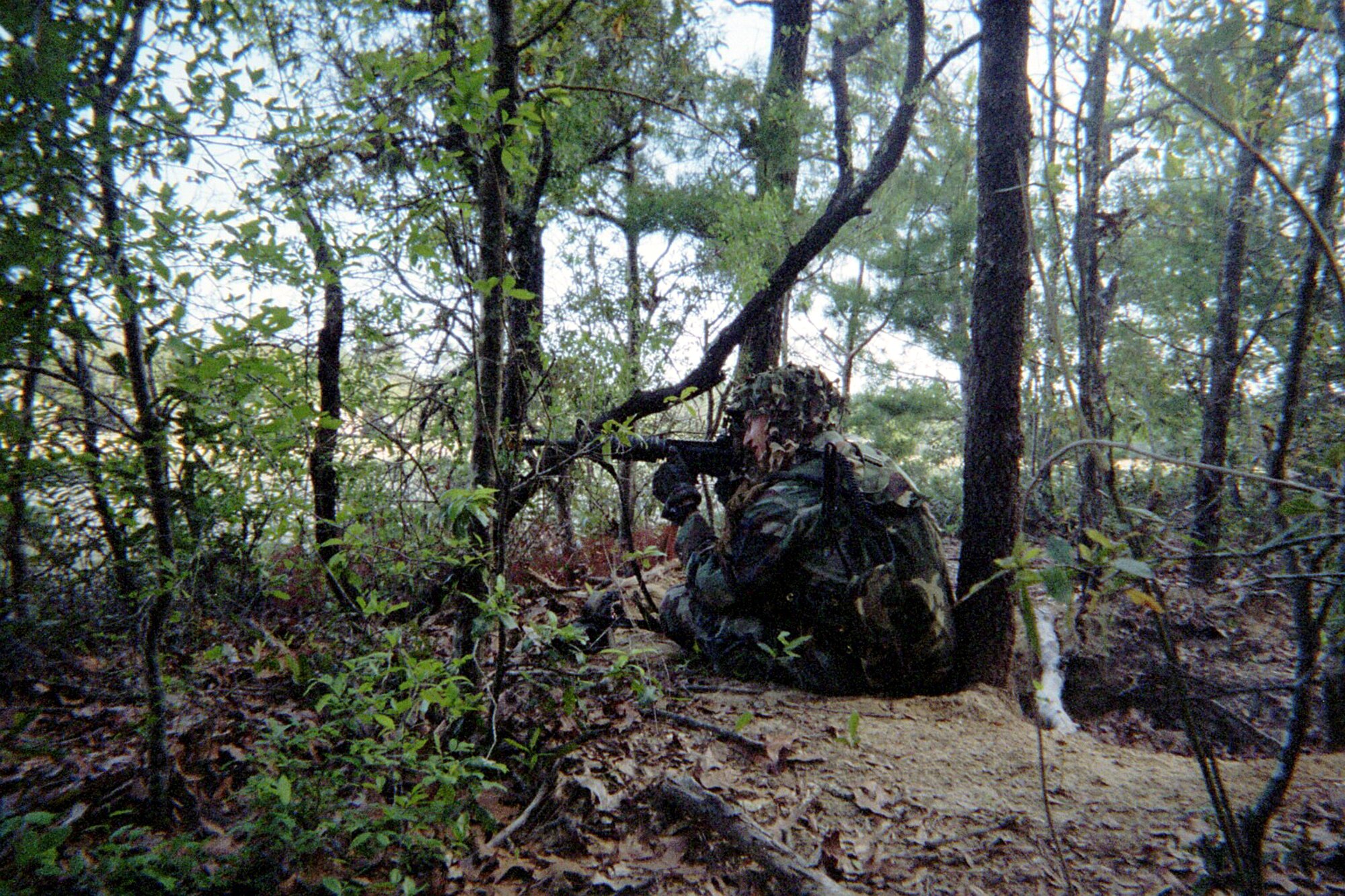 Tech. Sgt. William Stapp, 919th Security Forces fire team member, monitors activities in a mock town for acts of hostility during a final Field Training Exercise in Military Operations in Urban Training on Eglin Air Force Base. In the event that he sees hostility against his team, he is cleared to eliminate the threat with a carefully placed shot. (U.S. Air Force Photo\Staff Sgt. John D. Glenister)