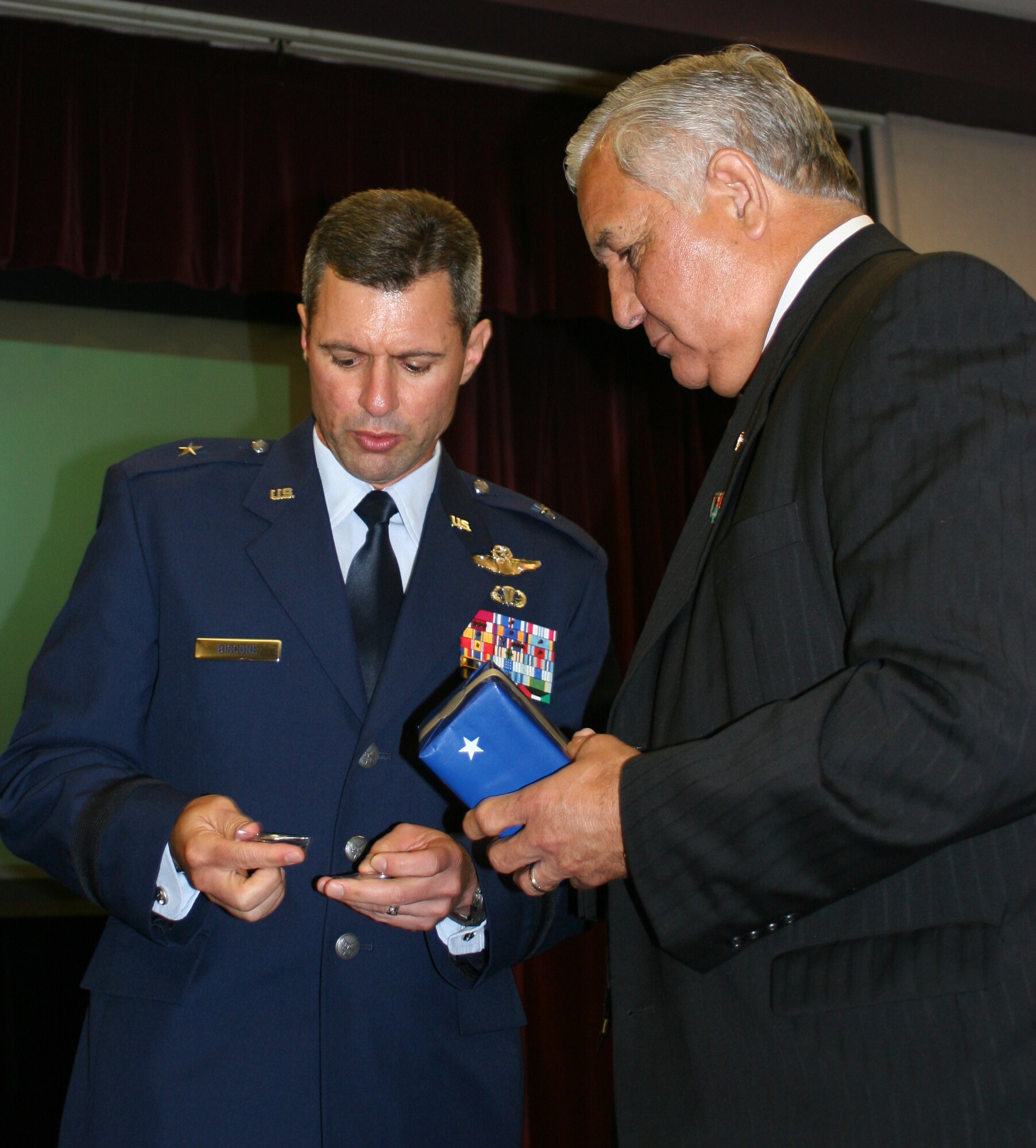 Brig. Gen. Greg Biscone, 509th Bomb Wing commander, presents a commander’s coin to Congressman Silvestre Reyes, who represents the 16th District of Texas in the U.S. House of Representatives, at the base community council luncheon at Mission’s End May 29. As a senior member of both the Armed Services and Select Intelligence Committees, Congressman Reyes is a key member of Congress on defense and military issues.  He attended the luncheon with Missouri Congressman Ike Skelton, and U.S. Navy Rear Admiral Mark Ferguson, Navy legislative affairs chief. Congressman Reyes, who served in the U.S. Army and is a Vietnam War veteran, thanked Whiteman members for their service and patriotism. (U.S. Air Force photo/Staff Sgt. Rob Hazelett)