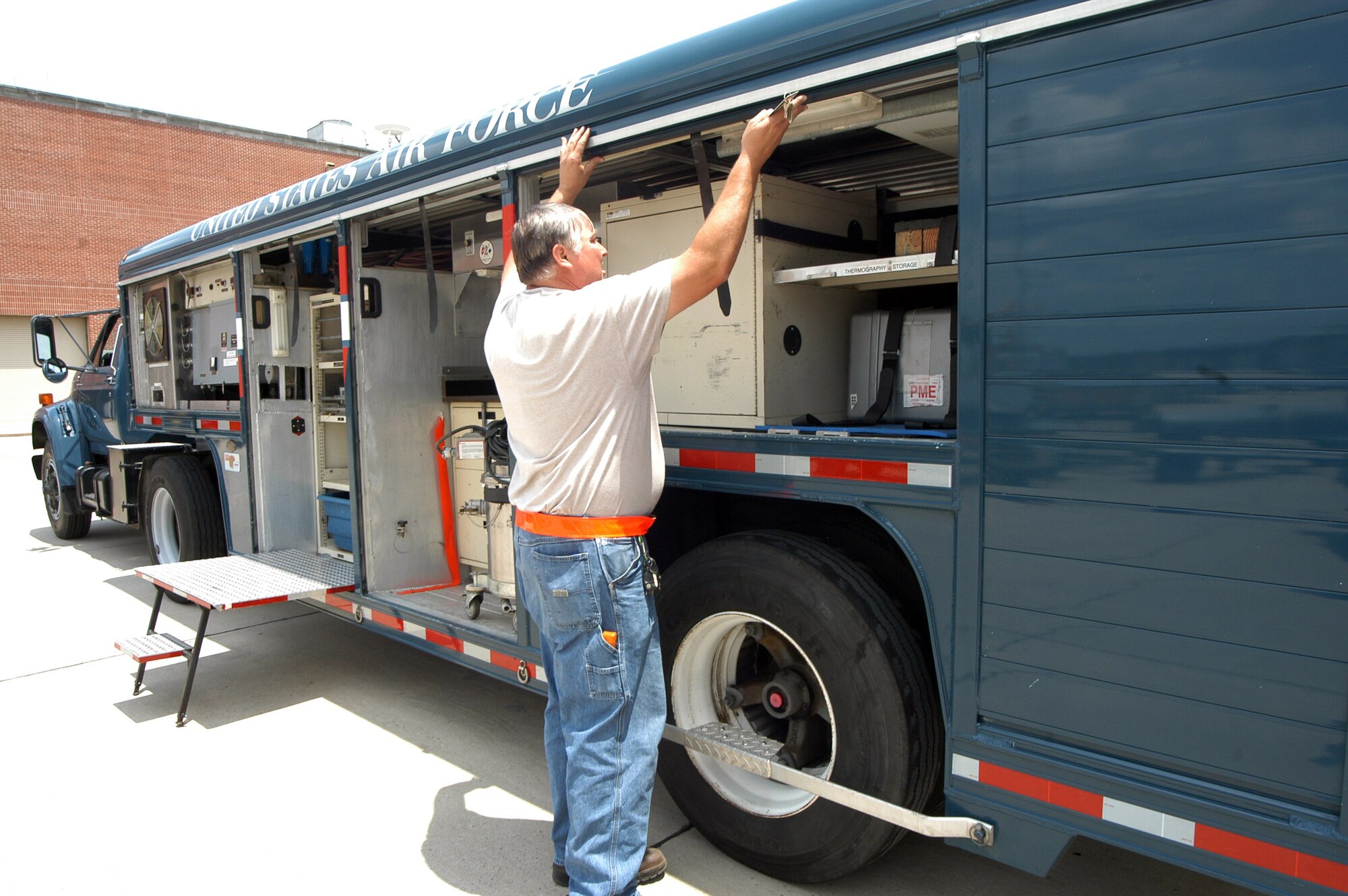 Allan Widener opens the panels of the War Wagon to reveal the equipment and supplies it holds in May at Robins Air Force Base, Ga. The 37-foot long, tractor-trailer based at the 402nd Commodities Maintenance Group deploys around the world with a traveling repairman in support of the warfighter anywhere at a moment's notice. Mr. Widener is a driver and mechanic from Robins AFB. (U.S. Air Force photo/Sue Sapp) 
