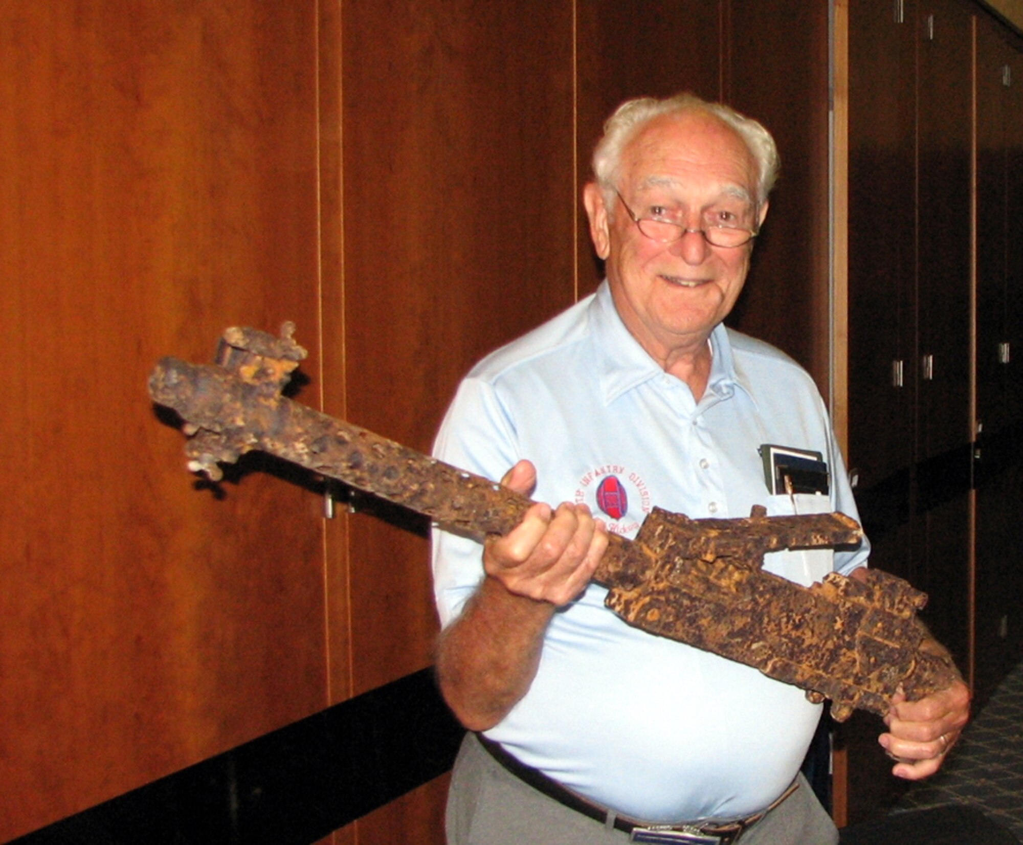 SPANGDAHLEM AIR BASE, GERMANY -- World War II veteran 1st Lt. Frank Towers holds a World War II-era 30-caliber machine gun that Roger Feller donated to the European Military History Group. The group hopes the machine gun will be the first of many guns added to their artifacts. Mr. Feller discovered the machine gun at an old farm house in Luxembourg May 21. Mr. Towers and Mr. Feller both spoke to Team Eifel May 24. (US Air Force photo/Master Sgt. George King)