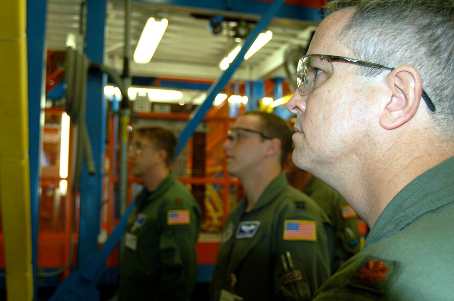 (Right to left) Maj. Kevin Higginbotham, 326th AS, along with Capt. Paul Scambos, 3rd Airlift Squadron and Maj. Justin Riddle, 3rd AS learn about the fabrication of the C-17 aircraft during a production facility tour May 30. The combined 436th and 512th Airlift Wings crew arrived in Long Beach, Calif. May 29 and will assume ownership of Dover Air Force Base's first C-17, the Spirit of the Constitution, May 31. The crew will fly the C-17 to Dover for the arrival ceremony June 4. (U.S. Air Force photo/2nd Lt. Nicki Langley)