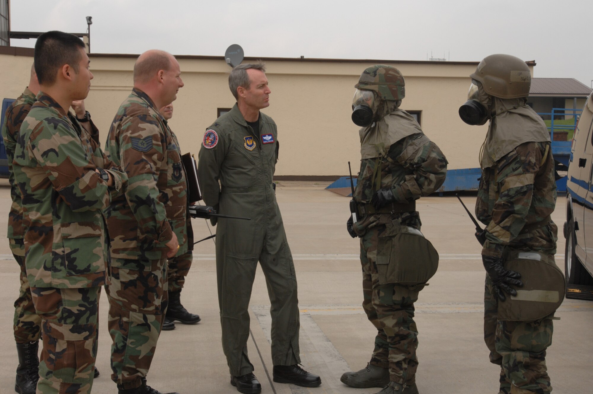 SPANGDAHLEM AIR BASE, GERMANY -- From left: 1st Lt. William Vu, 52nd Aircraft Maintenance Squadron, Tech. Sgt. Michael Powers, 52nd Logistics Readiness Squadron, Col. Darryl Roberson, 52nd Fighter Wing commander, and Tech. Sgt. Timothy Beers and Staff Sgt. Benjamin Turner from 52nd LRS in chemical protective gear. Lieutenant Vu spent the day with the commander as part of the Commander’s Shadow Program. Lieutenant Vu, a Houston native, is an assistant officer in charge with the 23rd Aircraft Maintenance Unit and leads more than 219 technicians in six AFSCs. He’s been in the Air Force for two years and hopes to earn a master’s degree in the next five years. He and the commanders observed Airmen from 52nd AMXS and 52nd LRS as they performed decontamination duties. The units demonstrated their war-fighting skills in preparation for the upcoming NATO OPEVAL. (US Air Force photo/Airman 1st Class Emily Moore) 