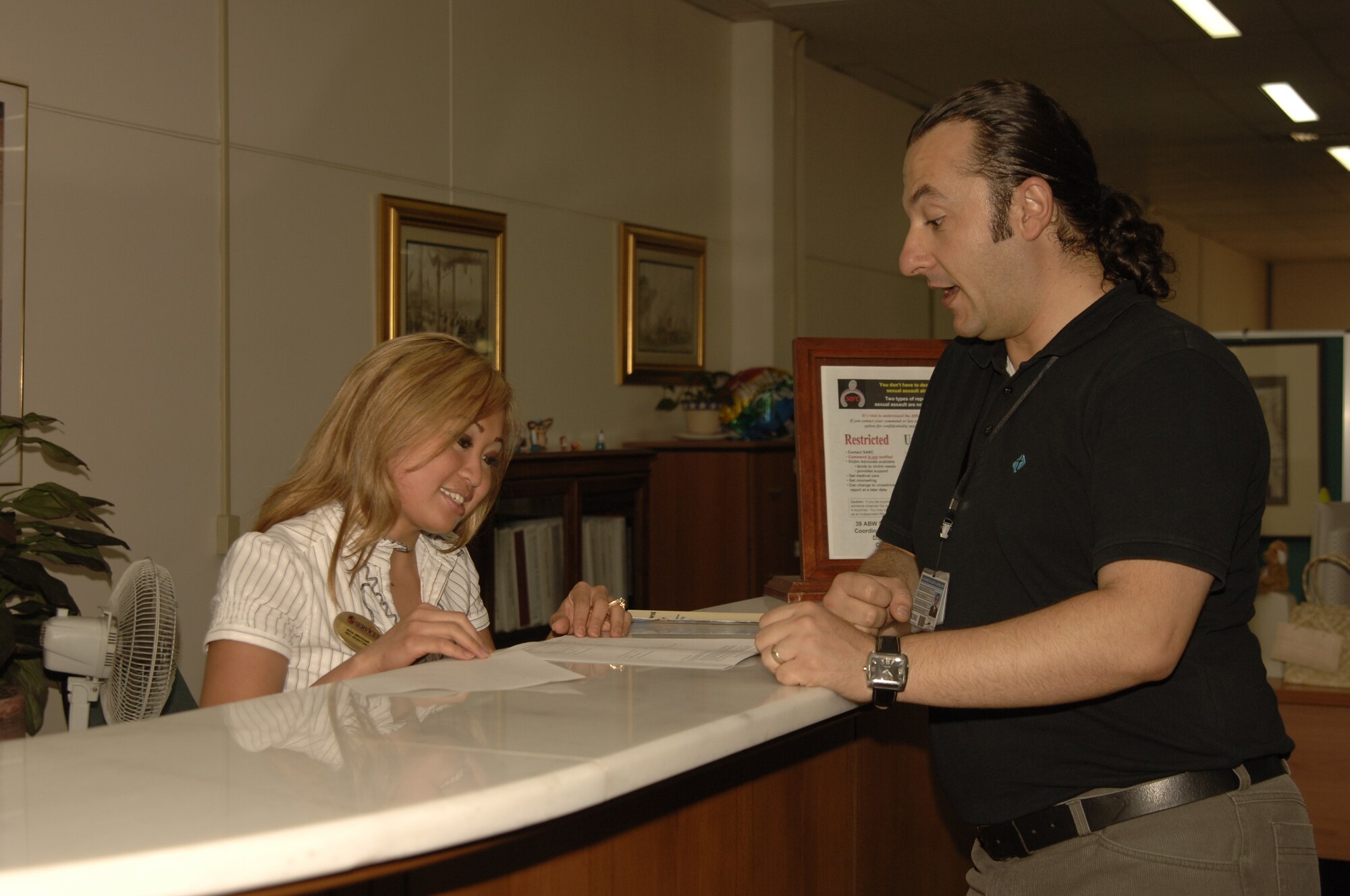 Nina Needham, 39th Services Squadron Human Resource Office assistant speaks with Serkan Duzler about job opportunities May 31.  Getting a job on base is a lot like getting a job in the states; you need to know where to start and who to talk to. (U.S. Air Force photo by Airman 1st Class Tiffany Colburn)


