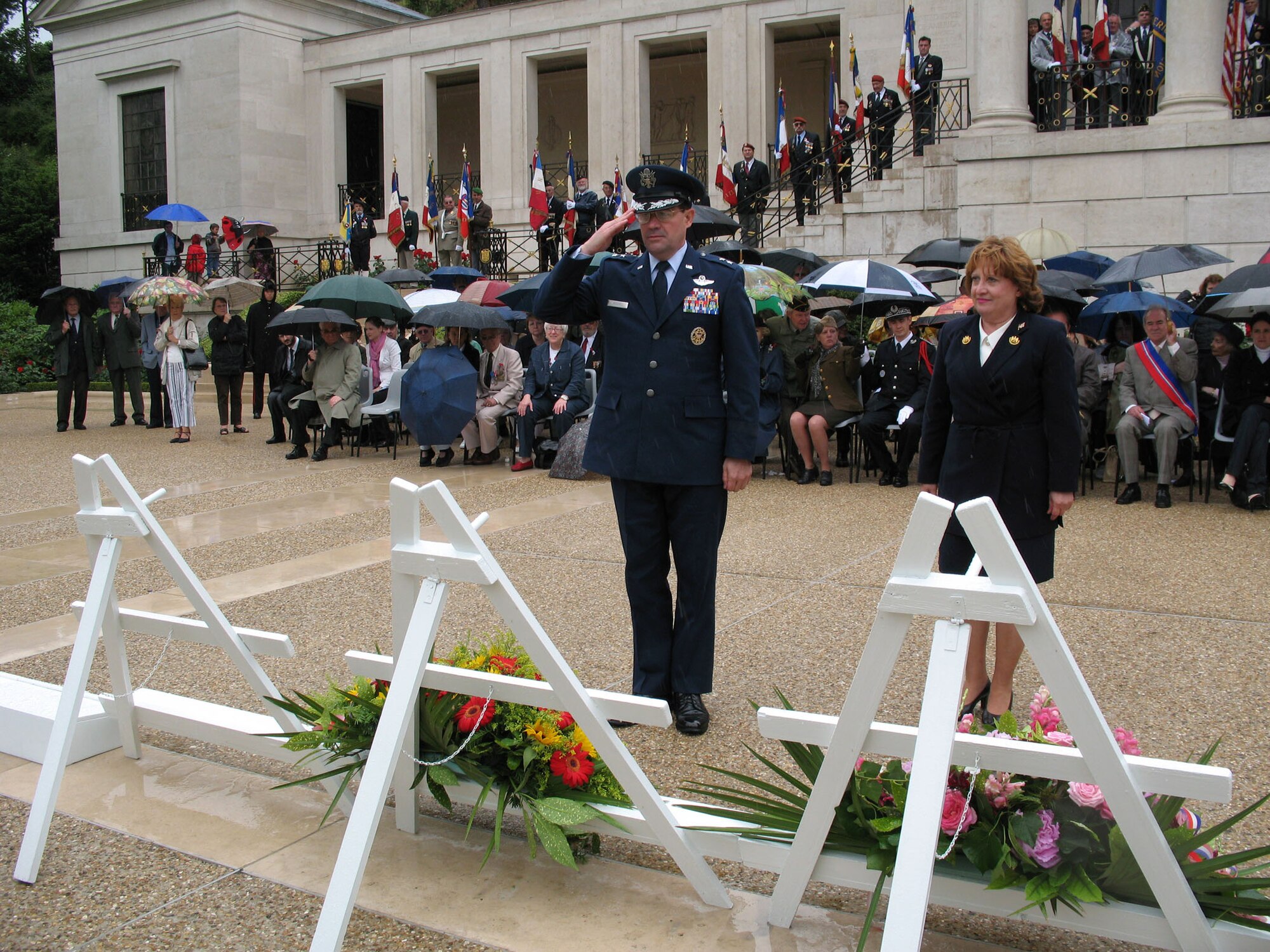 Maj. Gen. Marc Rogers, U.S. Air Forces in Europe vice commander, salutes after laying a wreath at the rainy Memorial Day ceremony at Suresnes American Cemetery in Paris May 27. In his speech at the event, the general said it was right that people should stand in the rain and honor those who fought and died for our freedom. Members of the USAFE Elite Guard Honor Guard concluded the ceremony with a 21-gun salute. (Photo by Capt. Chris Watt)