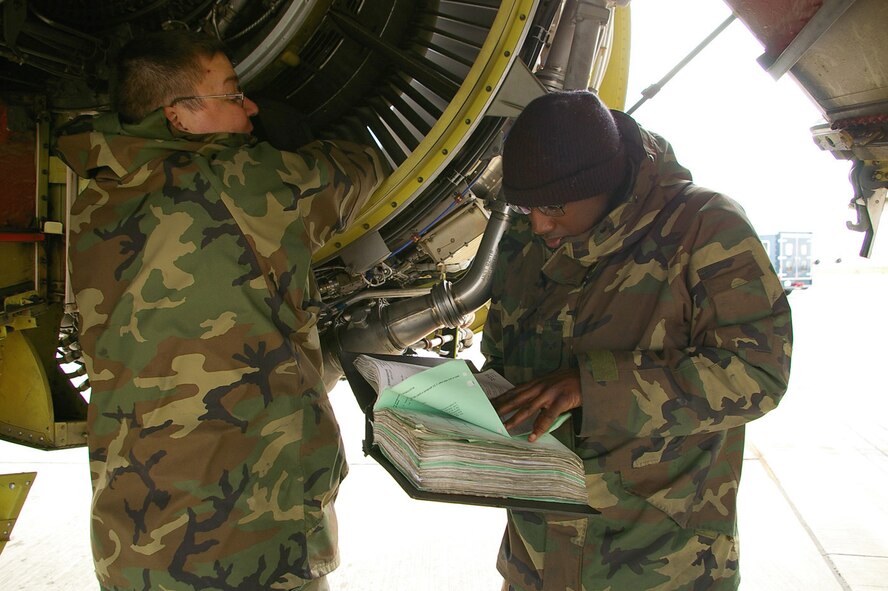 Senior Airmen David Elliot, left, and Stephen Walker, both 100th Aircraft Maintenance Squadron, change an aircraft acoustical panel on an engine on aircraft tail number 8879. Both Airmen are specialists who work alongside the crew chiefs on the aircraft. Tail number 8879 is one of two aircraft which has recently received 100+ on-time flights. (U.S. Air Force photo by Karen Abeyasekere)