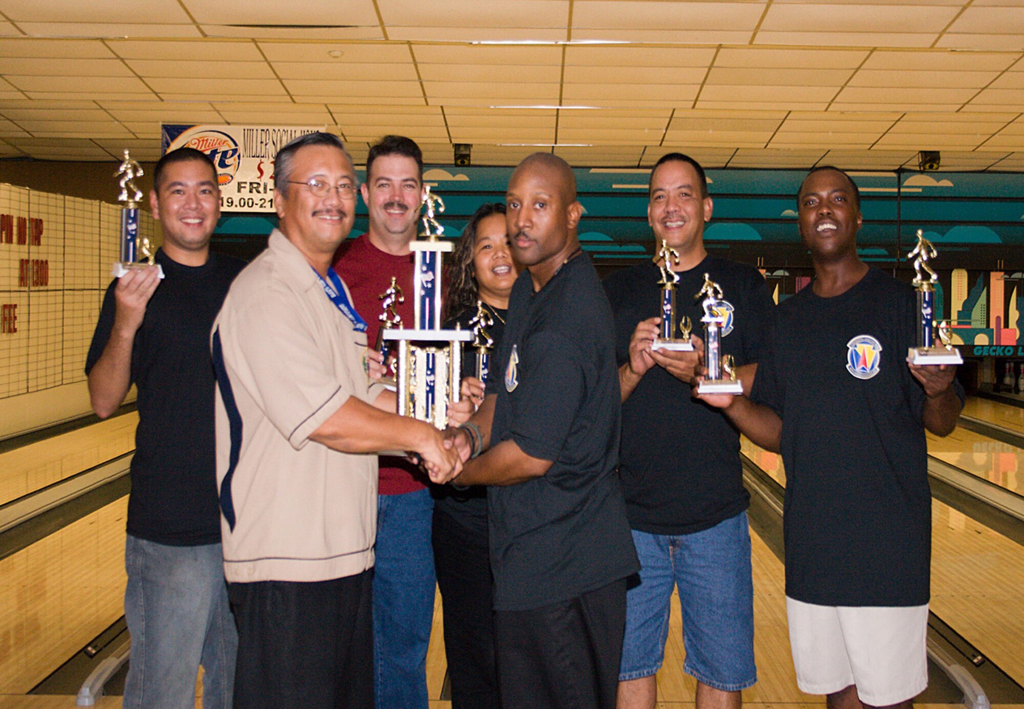 The 36th Civil Engineer Squadron intramural bowling team displays their trophy after winning the base intramural championships.