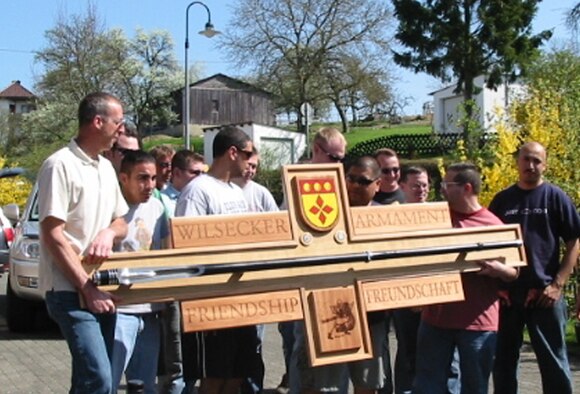 SPANGDAHLEM AIR BASE, GERMANY -- Airmen from the 52nd Equipment Maintenance Squadron present a sign they made to Wilsecker Mayor Edeltrud Hilden and residents to symbolize the unit’s relationship with the village after the two groups spent the day working together during Clean Up Wilsecker Day. (Photo by Diana Frisch) 