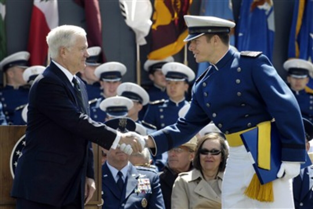 Secretary of Defense Robert M. Gates congratulates a member of the U.S. Air Force Academy's Class of 2007 during the graduation ceremony at Colorado Springs, Colo., on May 30, 2007.  Gates delivered the commencement address to the 976-member graduating class.  