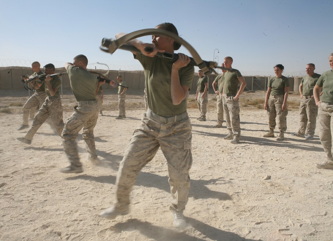AL ASAD, Iraq- Marines from Marine Aviation Logistics Squadron 29 execute the smash, a bayonet technique while remediating tan techniques during a gray belt Marine Corps Martial Arts Program course, Nov. 1.  The students spend approximately four hours every day for a month learning the martial arts techniques and warrior studies to earn their gray belts.