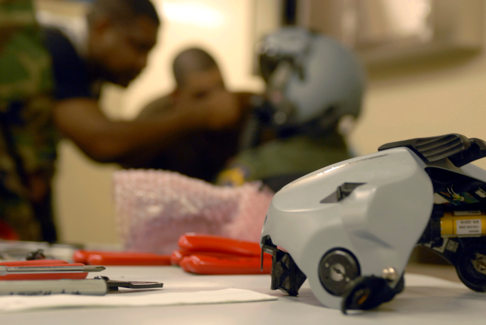 KUNSAN AIR BASE, South Korea -- A 50,000 dollar display unit sits awaiting to be fitted on a new helmet as Captain Darin Wetzler is fitted for his new Joint Helmet Mounted Cueing System Nov. 1 here. Airman received hands-on training from a Boeing instructor on how to size, fit, inspect and maintain the JHMCS helmet and related sub-systems. (U.S. Air Force photo/Senior Airman Steven R. Doty)