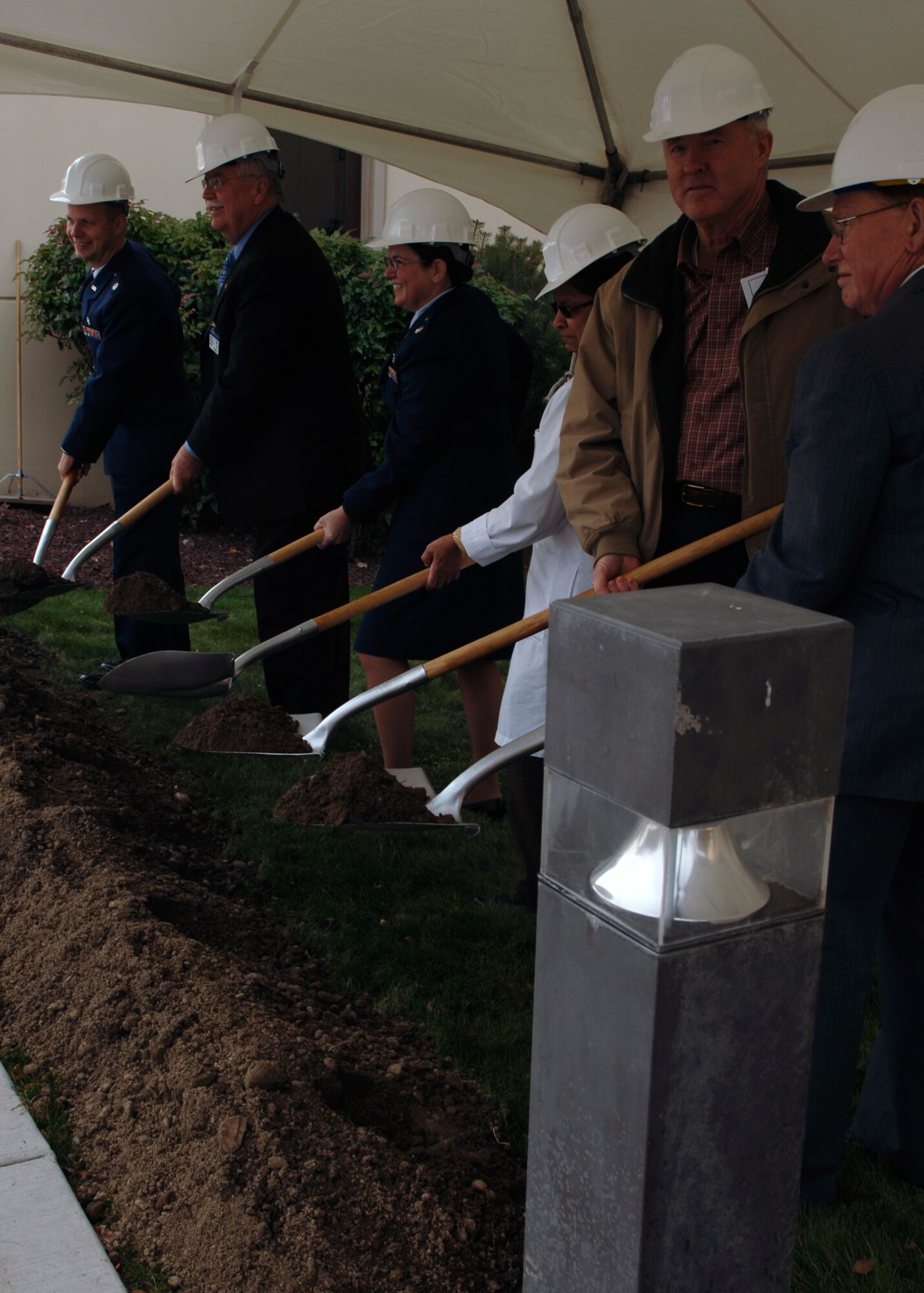FAIRCHILD AIR FORCE BASE, Wash. -- Lt. Col. Gregory DeWolf, 92nd Medical Support Squadron commander; Hal Blair, Spokane Veterans Medical Center acting director;  Lt. Col. Theresa Sparkman, 92nd Medical Group medical staff chief; Dr. Nirmala Rozario, Jerry Burton, Burton Construction, Inc. owner; and Dr. Joel Sim participate in the ground-breaking ceremony of the TESLA MRI Project at the VAMC on Oct. 31. This is a joint venture between Fairchild and the Spokane VAMC. (U.S. Air force photo / Airman 1st Class Darlene West)
