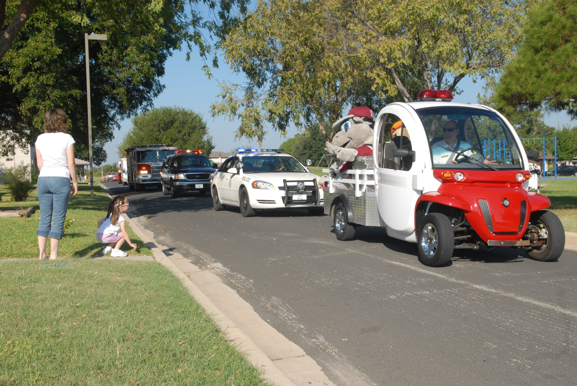 A parade of emergency and fire rescue vehicles move in procession during the Goodfellow Air Force Base Fire Department’s 2007 Fire Prevention Week Parade in Lanham Base Housing Oct. 5. (U.S. Air Force photo by Airman 1st Class Kamaile Chan)
