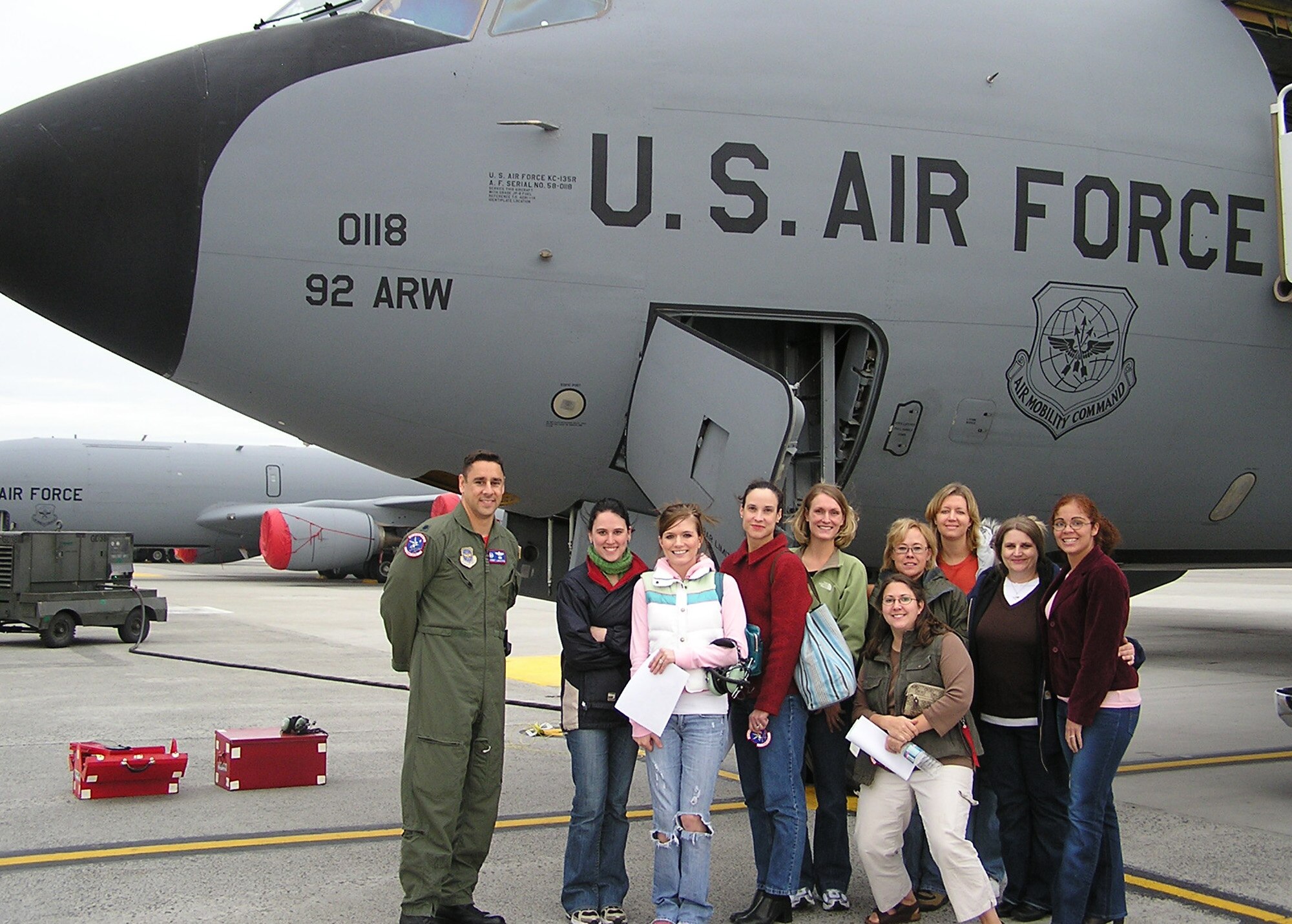 FAIRCHILD AIR FORCE BASE, Wash. -- Lt. Col. Glenn LeMasters, 93rd Air Refueling Squadron commander, and spouses of 93rd ARS Airmen stand in front of a KC-135 Stratotanker on the flight line prior to an incentive flight for the spouses. The intent behind the incentive flight was to provide the spouses with a greater understanding of what the 93rd ARS Airmen do. (Courtesy photo)