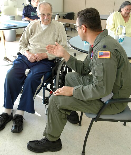 SPOKANE, Wash. -- Lt. Col. Glenn LeMasters, 93rd Air Refueling Squadron commander, visits with a veteran at the U.S. Veterans Medical Center nursing home Oct. 26. Colonel LeMasters, along with other Airmen of the 93rd, visited the nursing home to share stories with the local veterans. (U.S. Air Force photo / Airman 1st Class Kali L. Gradishar)