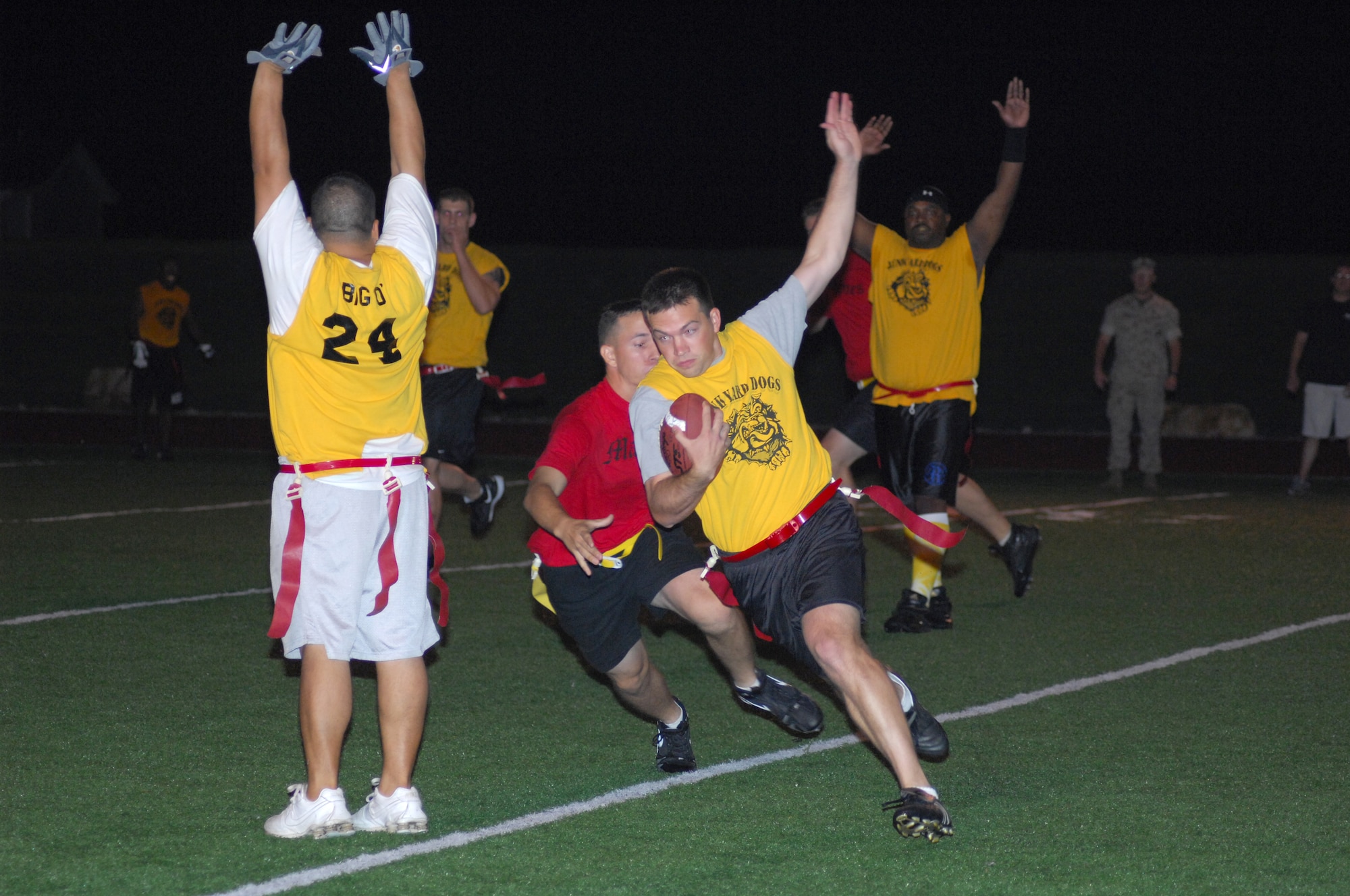 Players from the 17th Mission Support Group Junk Yard Dogs, come to halt and raise their hands to avoid getting a penalty as Ross Davis, cornerback, runs scramble down the field and up the sidelines for a score after intercepting the ball and running it for a defensive touchdown during the last two minutes of the 2007 Goodfellow Flag-football Championship game Sept. 27 at the base football field. The JYD defeated the Marine Corps Leathernecks 24-0. Thursday’s victory marks the fourth time the Dogs have won the GFL title in five years. (U.S. Air Force photo by Staff Sgt. Angela Malek.)