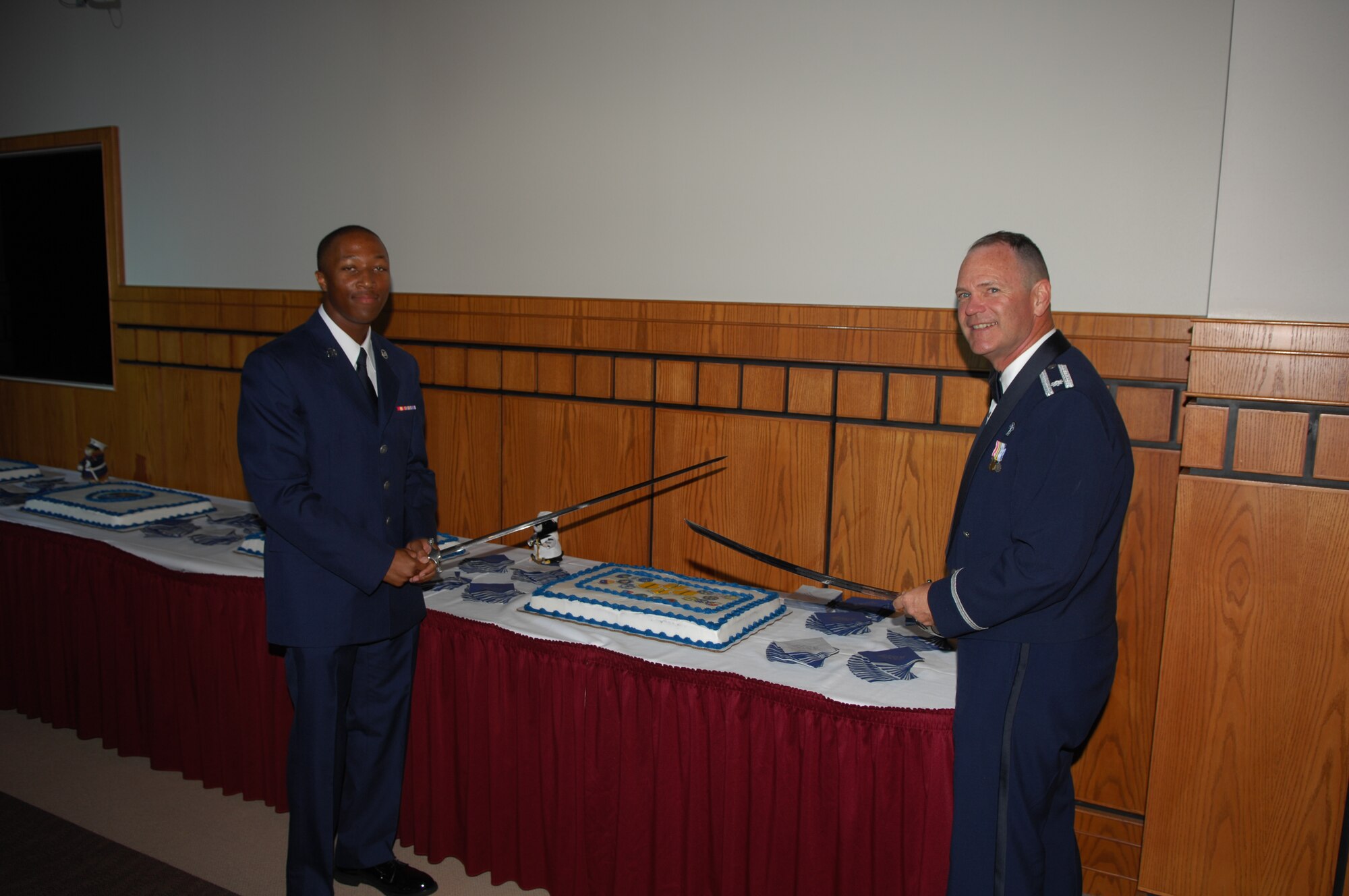 Airman Basic Dwayne Lee, the youngest Airman at the Air Force Ball, and Chaplain (Lt. Col.) James Ludwikowski, 17th Training Wing Chaplain and the oldest Airman at the ball, prepare to cut the cake Sept. 29. (U.S. Air Force photo by Staff Sgt. John Barton)