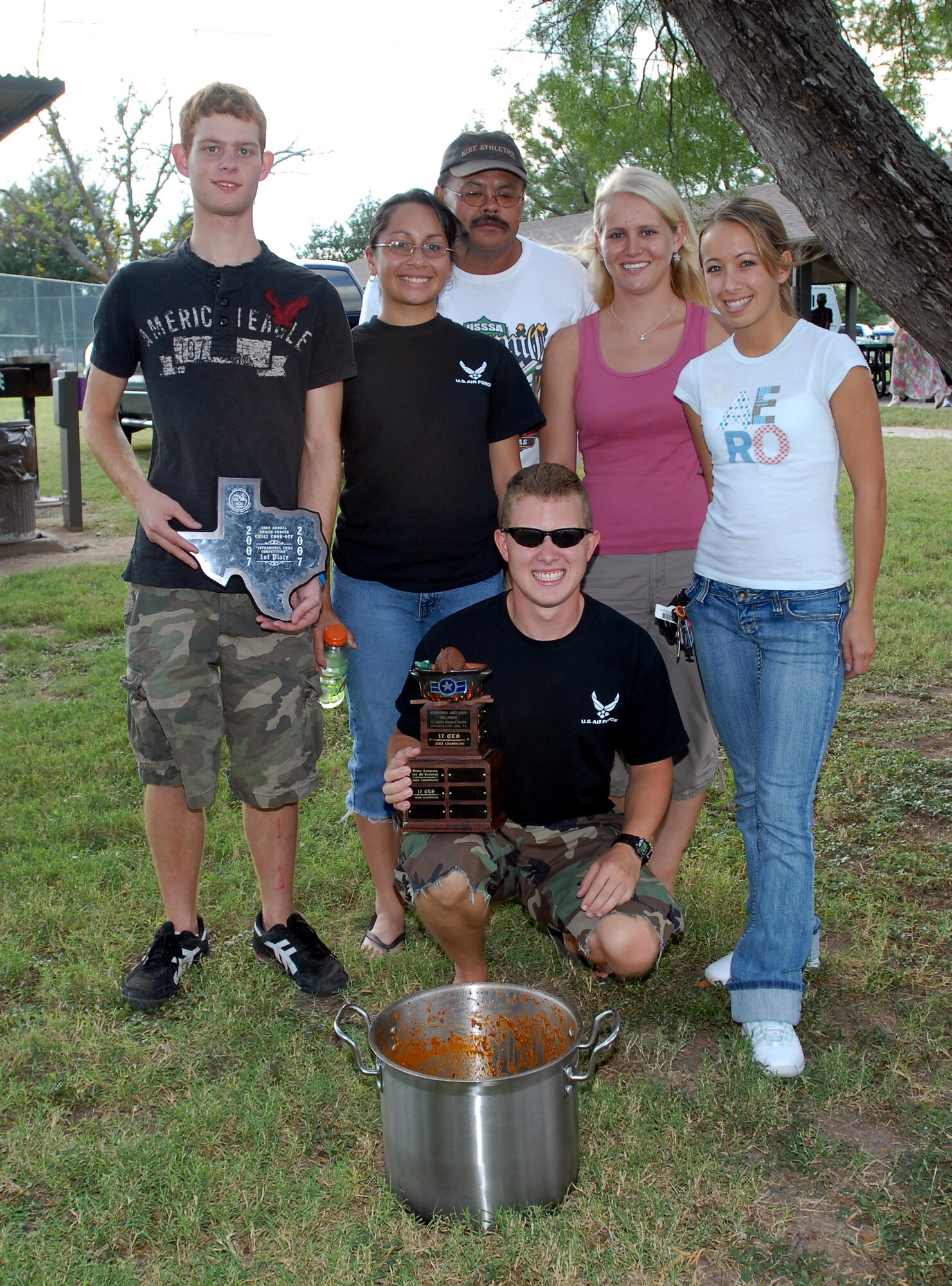 Winners of the 33rd Annual Armed Forces Chili Cook Off amateur division pose for a group shot with their chili Sept. 29. at Lake Nasworthy. The winning team was represented by (front, kneeling) Reserve Officer Training Corps Cadet Lt. Col. Ryan Kraus, (middle row, left to right) Cadet 4th Class Jeff Jones, Cadet 3rd Class Myra Gomez, Ashley Ward, Cadet Major Angela Clapp and (back) Richard Asebedo. While not part of the Air Force Ball festivities, the chili cook off added a little more military pride to an already-heritage-filled weekend. (U.S. Air Force photo by Tech. Sgt. Gina O’Bryan)