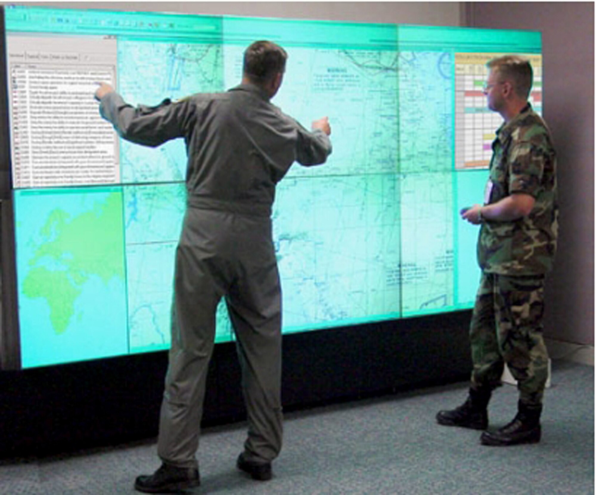 Two Airmen demonstrate Warfighter's Edge, or WEdge, a new command and control tool designed to automate briefings for aircrews, organizes information and delivers it to users in a tailored, real-time format. (U.S. Air Force photo)