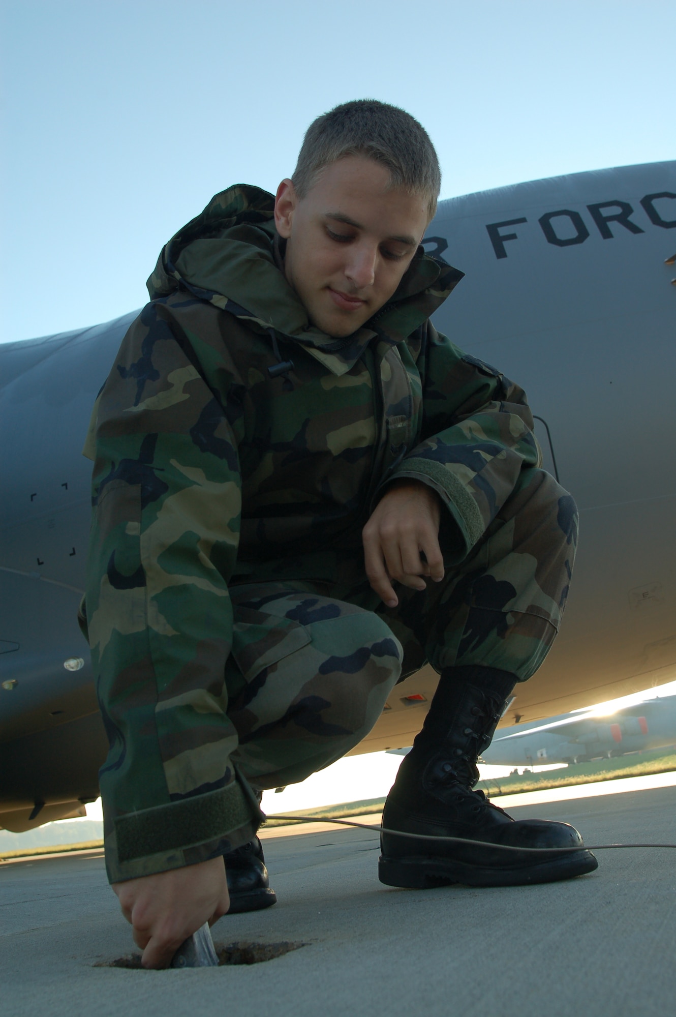 Airman 1st Class Alexander Keel, 736th AMXS crew chief and Orlando, Fla. native, connects a grounding wire before performing maintenance on a C-17 Globemaster Wednesday. (U.S. Air Force photo/Senior Airman James Bolinger)