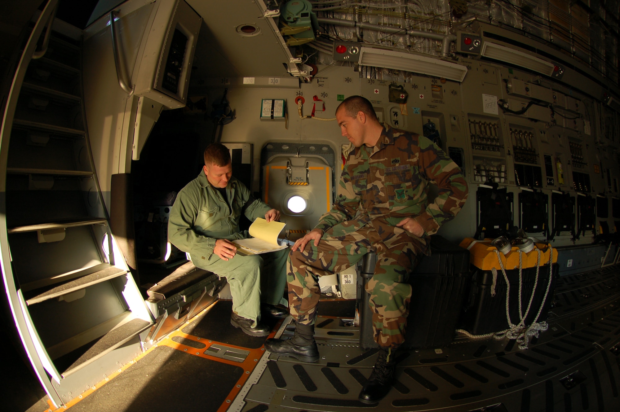 (Right to left) Staff Sgt. Jeremiah Kincade, 736th Aircraft Maintenance Squadron C-17 crew chief and Milford, Del., native, discusses technical orders with Staff Sgt. Damon Montugaue, 736th AMXS aerospace propulsion craftsman and San Jose, Calif. native. The 736th AMXS was created earlier this year and handles all flightline C-17 maintenance for Dover. (U.S. Air Force photo/Senior Airman James Bolinger)