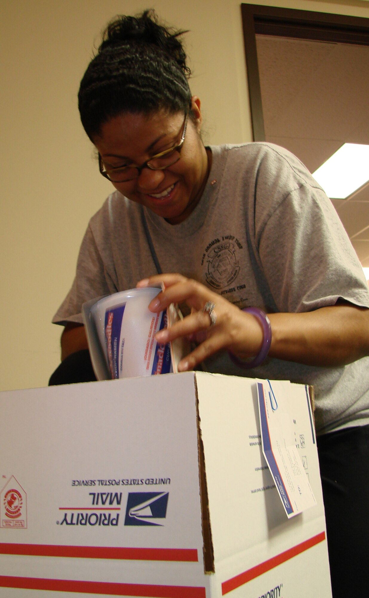 Trista Huinker, wife of Capt. David Huinker, 71st Medical Support Squadron who is currently deployed to Afghanistan until March, packs care packages during Operation Cookie Cutter Nov. 1 at Airman and Family Readiness Center. (U.S. Air Force photo by Tech. Sgt. Mary Davis) 
