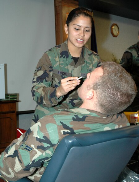Airman 1st Class Malaya Movido, 341st Medical Operations Squadron medical technician, administers a nasal-spray flu vaccine to Airman 1st Class Matthew Splichal, 341st Space Wing Safety Office ground safety apprentice. The first 500 nasal-spray flu vaccines were available at the wing headquarters building Nov. 1. An additional 3,500 doses are expected to arrive in approximately three weeks. The nasal-spray flu vaccine is the Department of Defense's primary method of administering flu vaccines to active-duty personnel in 2007. (U.S. Air Force photo/Airman 1st Class Dillon White)