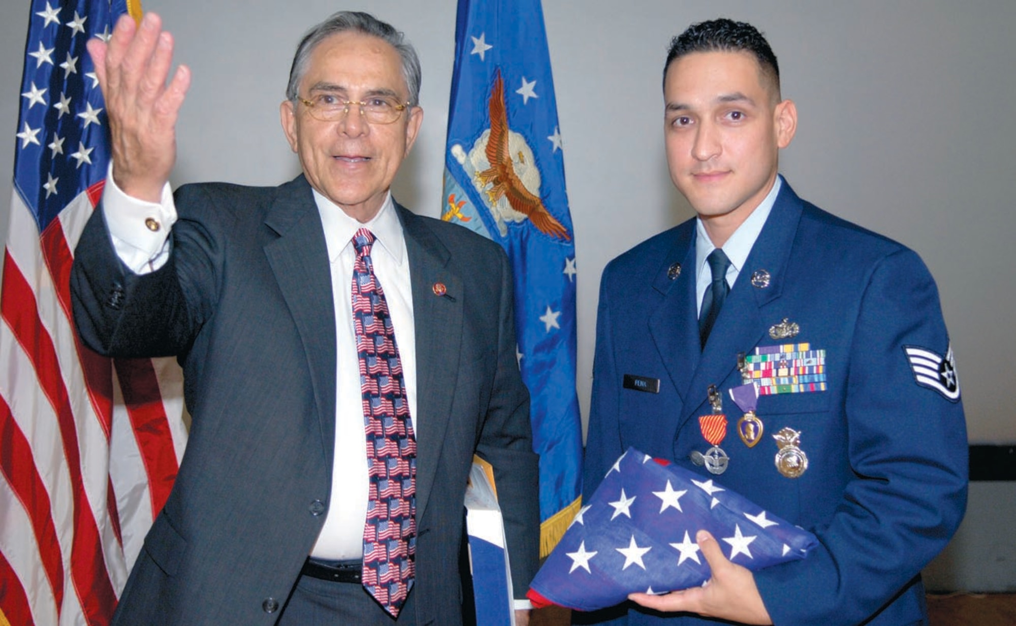 Staff Sgt. Daniel Pena, 316th Security Forces Squadron, was awarded a Purple Heart for wounds received in battle, while deployed, as well as the Air Force Combat Action Medal. Sergeant Pena had the honor of Congressman Ruben Hinojosa, 15th District of Texas, in attendance during the ceremony on Oct. 26. (US Air Force/A1C Renae Kleckner)