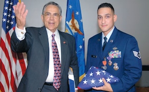 Staff Sgt. Daniel Pena, 316th Security Forces Squadron, was awarded a Purple Heart for wounds received in battle, while deployed, as well as the Air Force Combat Action Medal. Sergeant Pena had the honor of Congressman Ruben Hinojosa, 15th District of Texas, in attendance during the ceremony on Oct. 26. (US Air Force/A1C Renae Kleckner)