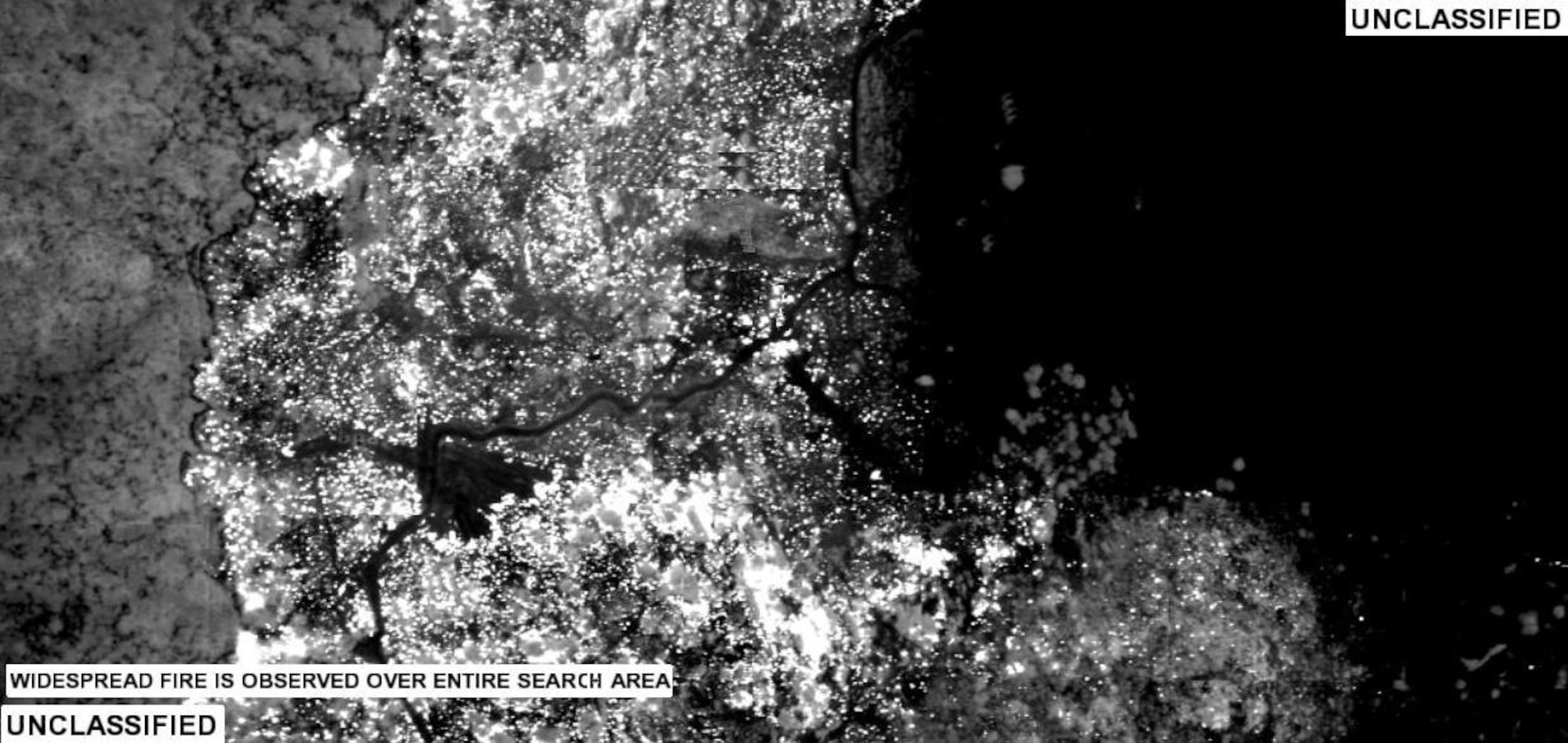 This photo was taken by a U.S. Air Force RQ-4A Global Hawk and analyzed for the wildfires in Southern California by an AN/GSQ-272 Sentinel imagery analyst. The infrared image depicts hot areas and objects as white on a darker background and shows the forward line of the Harris Fire. (U.S. Air Force photo)