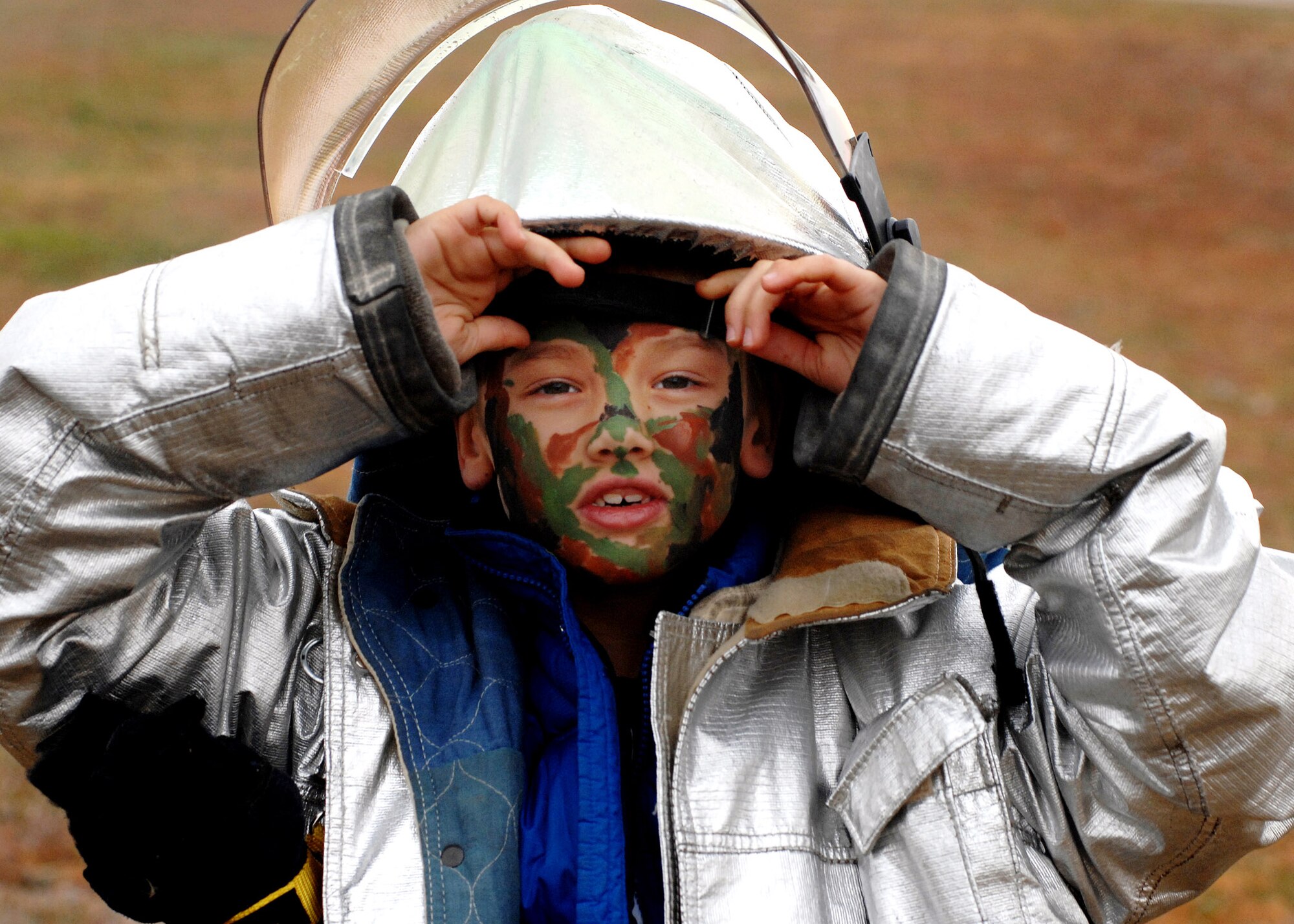 Second grader Matthew Kochman patiently waits in line for an attack hose demonstration hosted by the base fire department during a children's deployment day Oct. 24 at Aviano Air Base, Italy. Matthew is the son of Master Sgt. Keith Kochman and Jessica Kochman. More than 200 children participated in the day-long event. (U.S. Air Force photo/Airman 1st Class Nathan Doza)