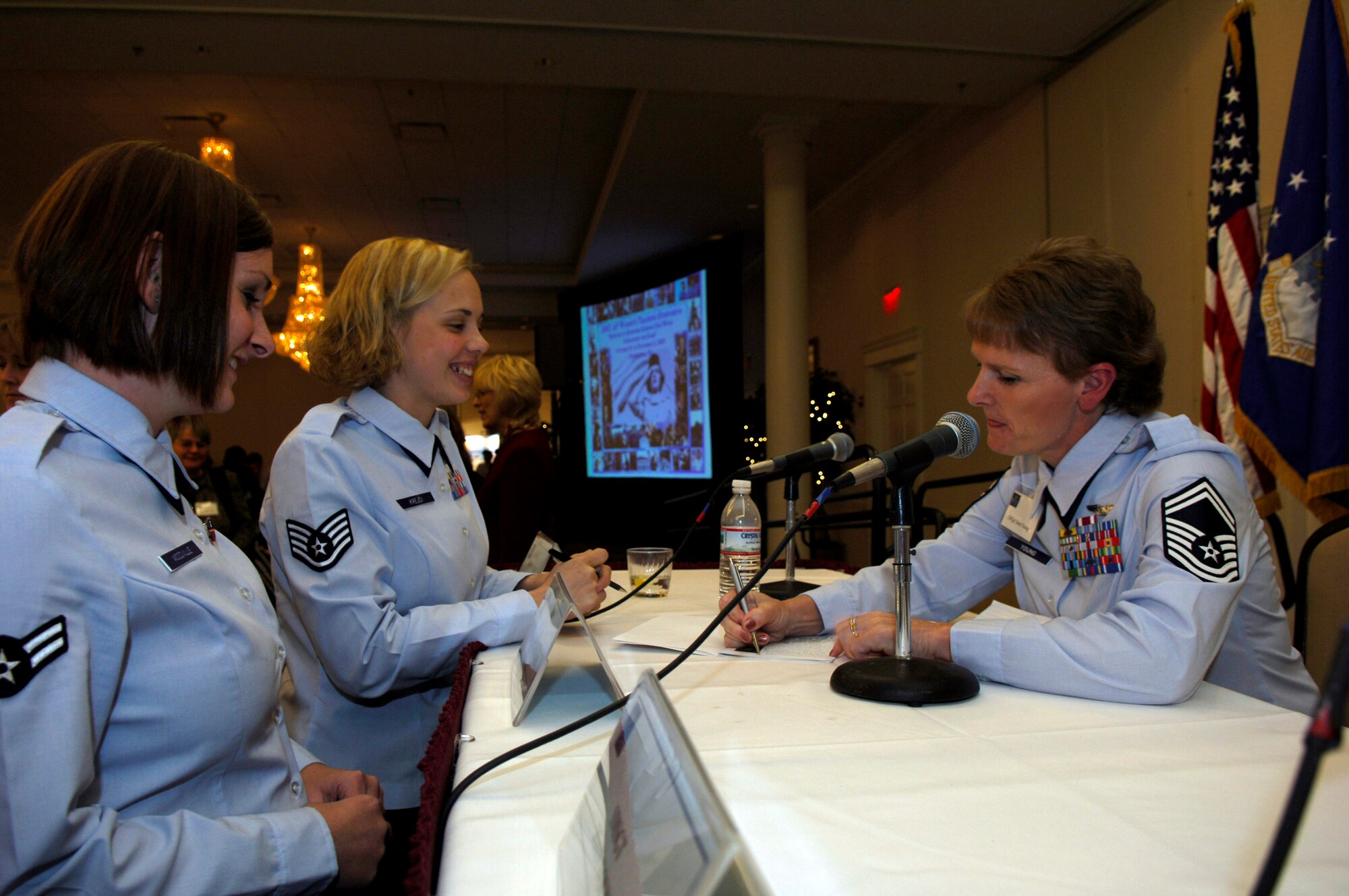 Senior Master Sgt. Joan Young, 1st Combat Camera Squadron, Charleston Air Force Base, S.C.,  gives her autograph to Staff Sgt. Lisa Krejci, 9th Comptroller Squadron, Beale AFB, Calif., at the 2007 Air Force Heritage to Horizon Women's Training Symposium in Springfield, Va., Oct. 31. (U.S. Air Force photo/Staff Sgt. Suzanne M. Day)
