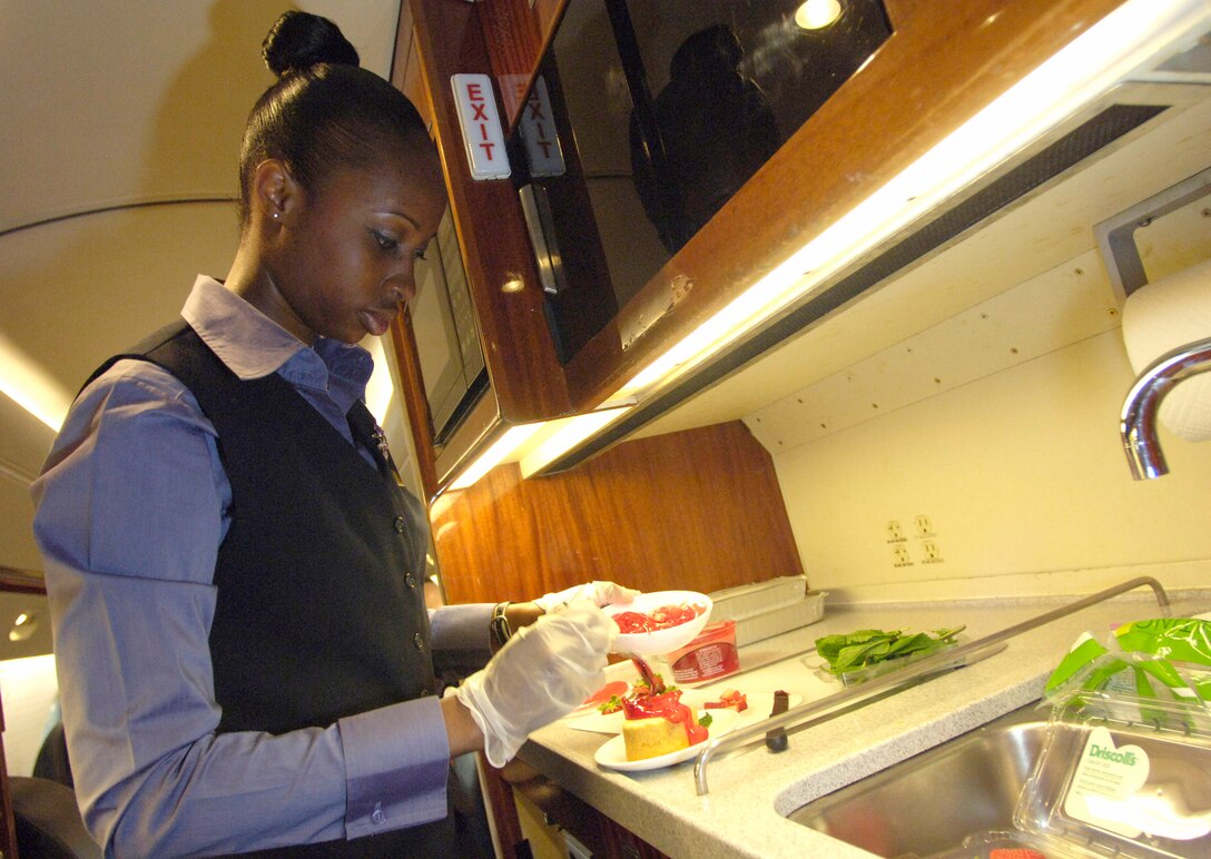 Staff Sgt. Danyoi Brown prepares a dessert course Oct. 31 in the galley of a C-37A aircraft. Sergeant Brown is a special air mission flight attendant with the 89th Airlift Wing's 99th Airlift Squadron at Andrews Air Force Base, Md. Though they prepare and serve food and beverages, the top priority of Air Force flight attendants are to ensure the safety of passengers and other crew members on board their aircraft. (U.S. Air Force photo/Master Sgt. Jim Varhegyi)