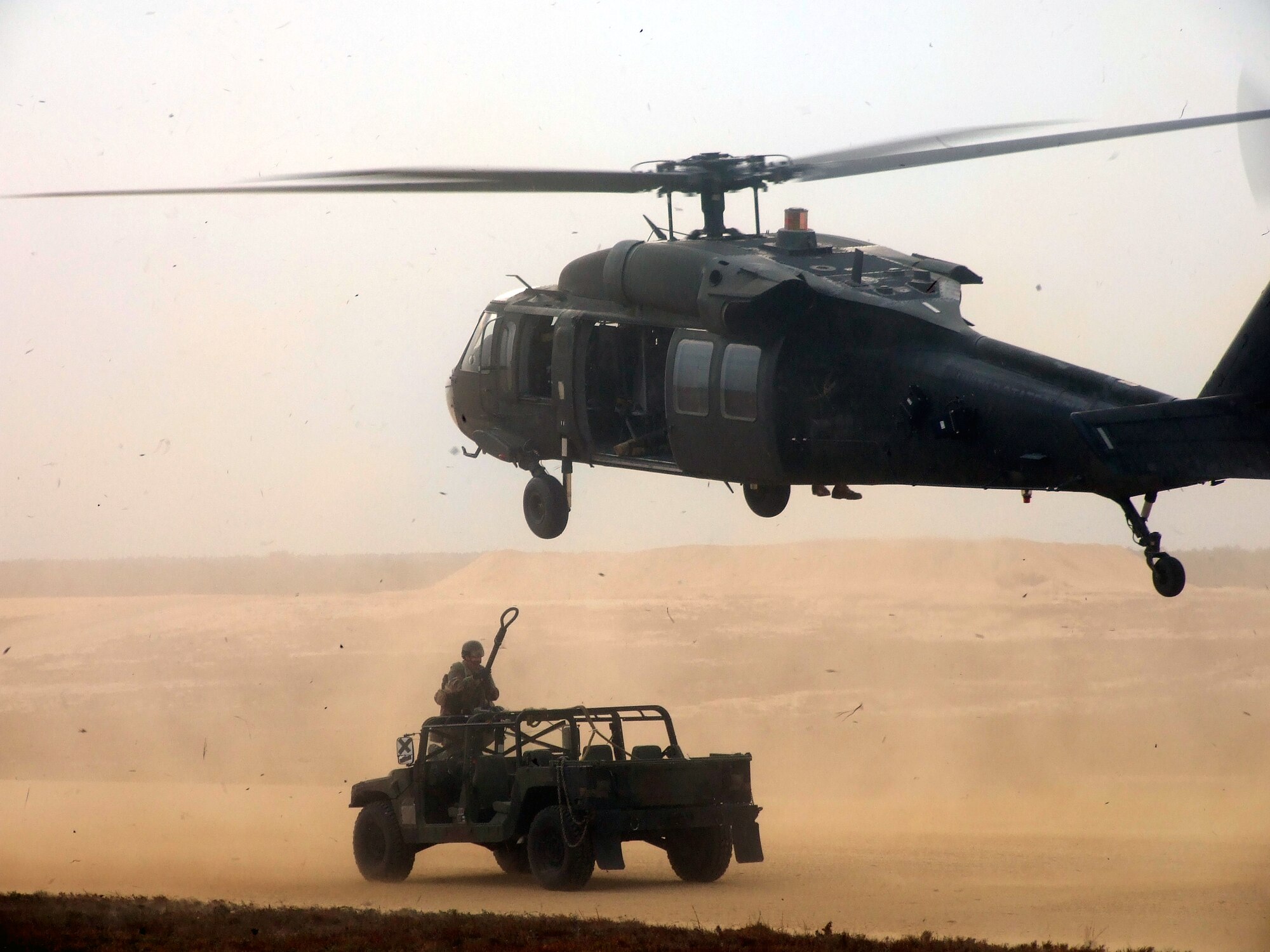 An Airman from the 818th Contingency Response Group, McGuire Air Force Base, N.J., prepares to attach a cable to a U.S. Army Blackhawk helicopter during "sling load" operations for Air Force Exercise Eagle Flag 08-1 Oct. 18 at Coyle Field in south New Jersey. The joint operations effort was a first for the exercise.  The helicopter is from the New Jersey Army National Guard's 1/150th Assault Helicopter Battalion of Trenton and Lakehurst.  (U.S. Air Force Photo/Tech. Sgt. Scott Meuller)