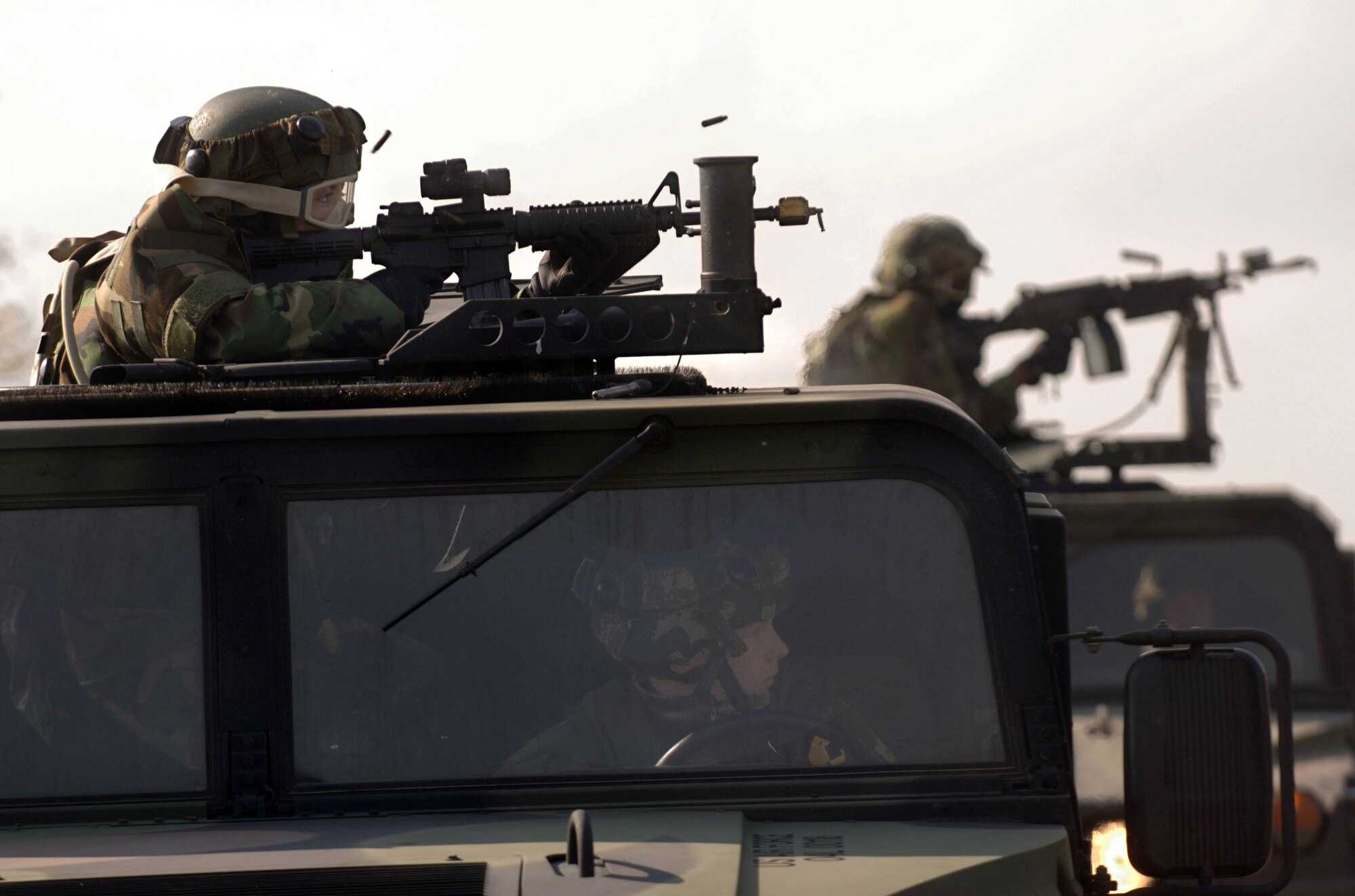 Airman 1st Class Amanda Hines responds to "hostile fire" from the turret of a mounted convoy patrol during Creek Defender Oct. 23 on Baumholder U.S. Army Garrison in southern Germany. The Airmen joined 105 other U.S. Air Forces Europe police in a two-week pre-deployment integrated base defense course. Each year the 786 Security Forces Squadron's regional training center, based at Sembach Air Base, Germany, trains 800 to 1,000 students. Airman Hines is assigned to the 48th Security Forces Squadron, at Royal Air Force Mildenhall, England. (U.S. Air Force photo/Master Sgt. Scott Wagers) 