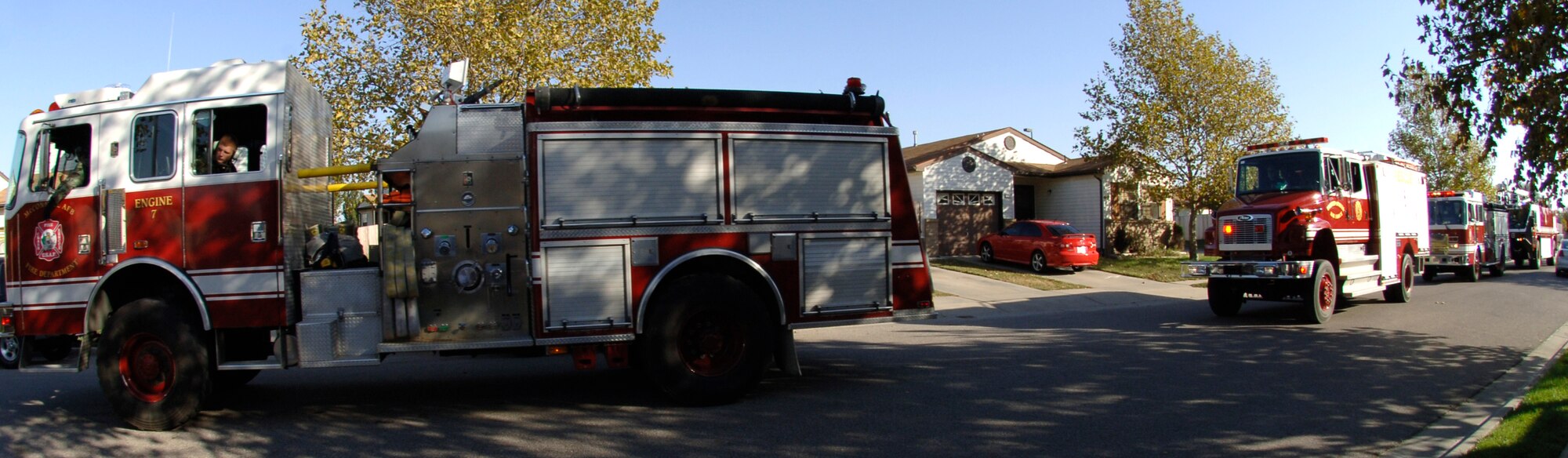 MCCONNELL AIR FORCE BASE, Kan. -- The 22nd Civil Engineering Squadron’s Fire Trucks travel Spicer Drive in Base Housing at the start of the Third Annual Fire Prevention Extravaganza Parade, Oct. 27. The Fire Extravaganza introduced McConnell residents to the base fire department and educates youths about fire safety and prevention. (Photo by Airman 1st Class Laura Suttles) 