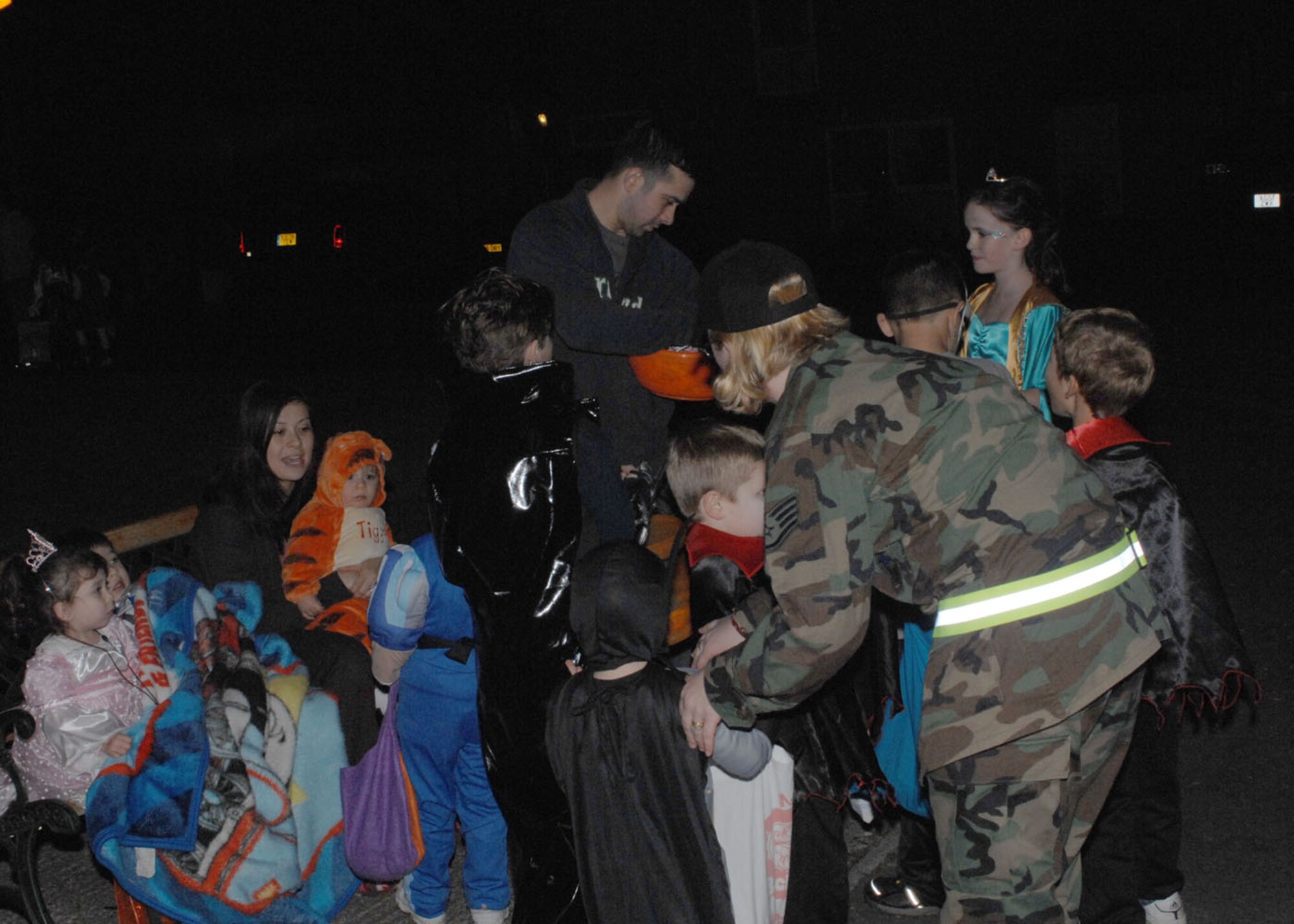 Staff Sgt. Caroline Vaughn, 48th Communications Squadron, helps with Pumpkin Patrol at RAF Lakenheath, England Oct. 31. Pumpkin Patrol is when Lakenheath members volunteer to keep the base housing streets safe during trick-or-treat peak times. (U.S. Air Force photo by Staff Sgt. Christopher Campbell)