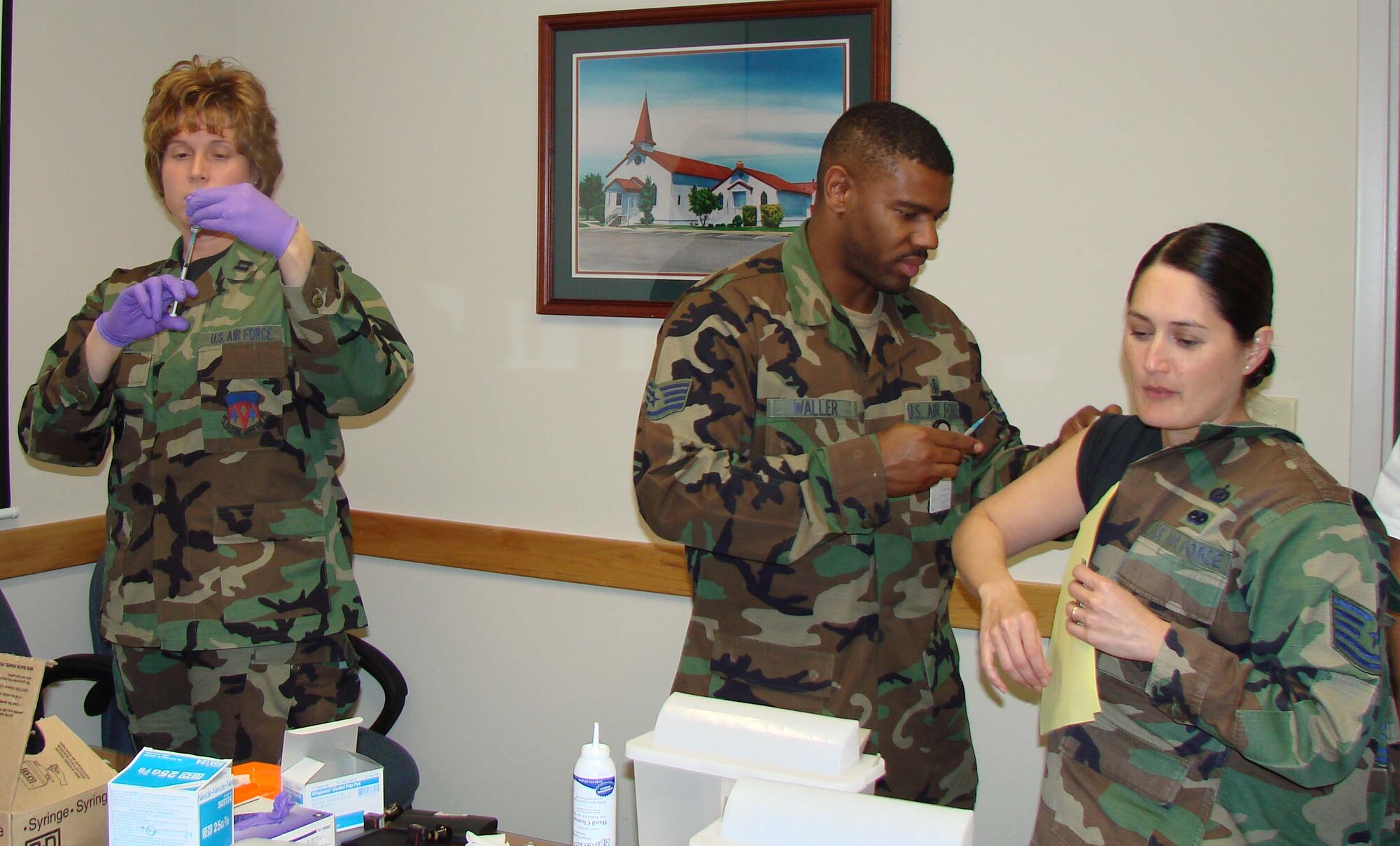 Capt. Dianne Stroble, 71 Medical Operations Squadron, prepares a syringe as Staff Sgt. Jemarlon Waller, 71st Medical Group, administers a vaccination to Tech. Sgt. Davis of 71st Flying Training Wing Public Affairs. Flu shots are required for all active-duty military personnel and are also administered, based on availability of supply, to patients deemed by their physicians to be at a higher risk of contracting influenza viruses, followed by active-duty dependents, civilian employees and government contractors. The high risk category also includes infants and those over age 65. In the last two weeks of October, the 71st Medical Group administered over 1,000 vaccinations. (U.S. Air Force photo by 2nd Lt. Agneta Murnan)